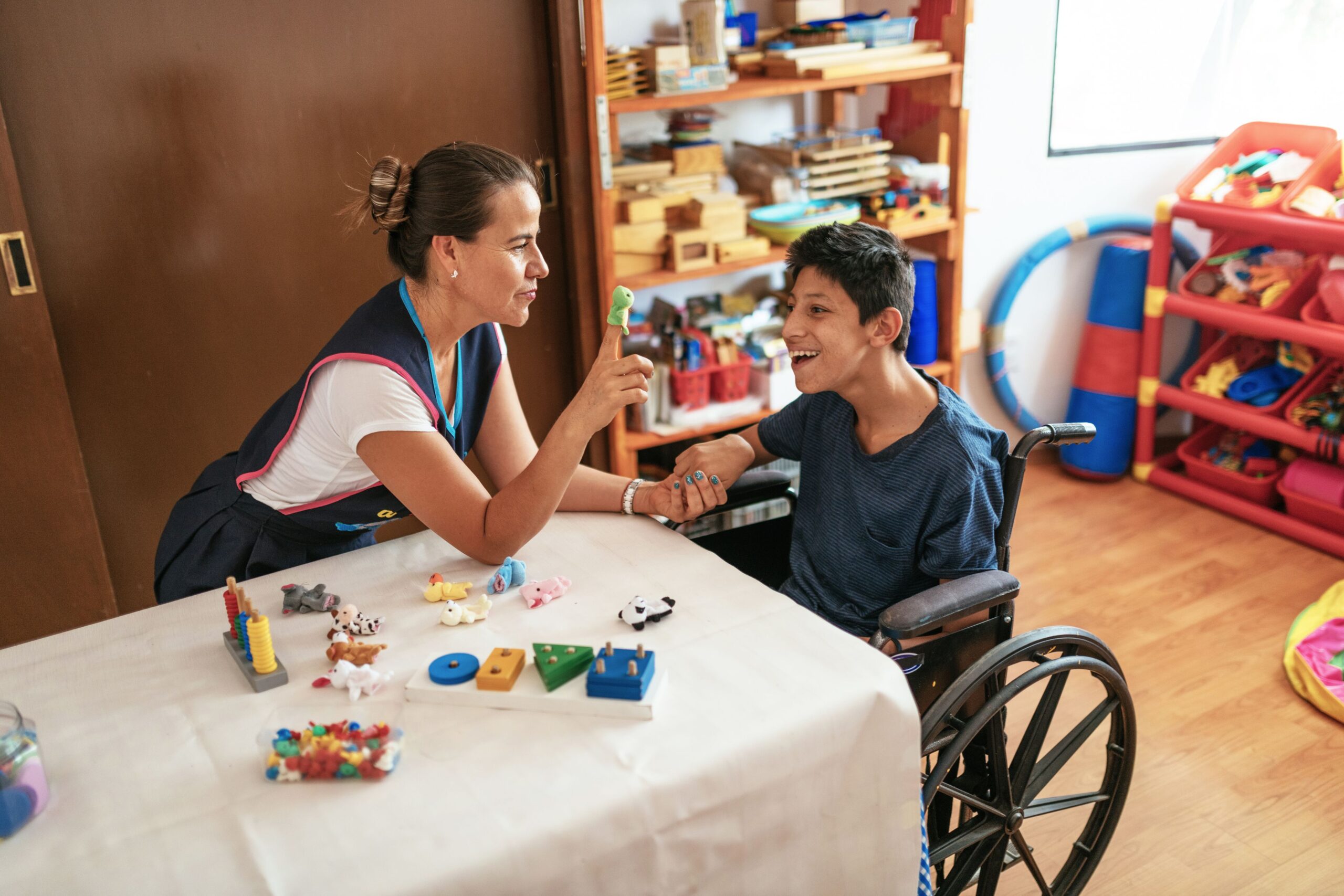 women working with boy with disability in a wheelchair