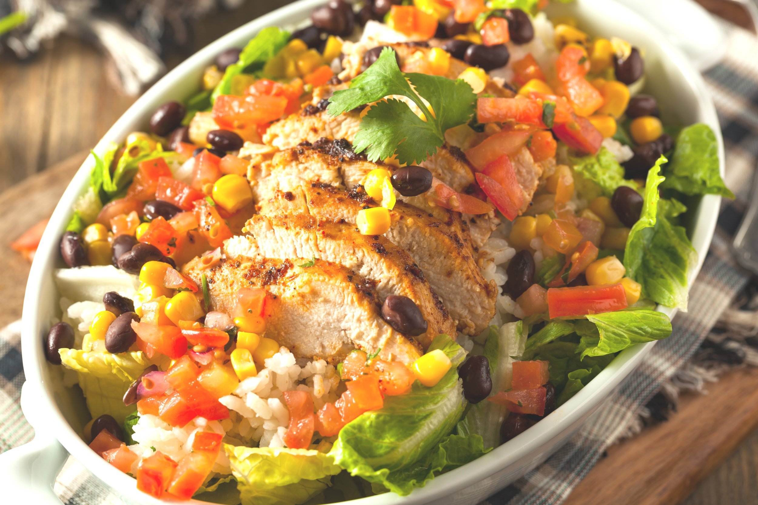 homemade mexican chicken burrito bowl with rice and beans