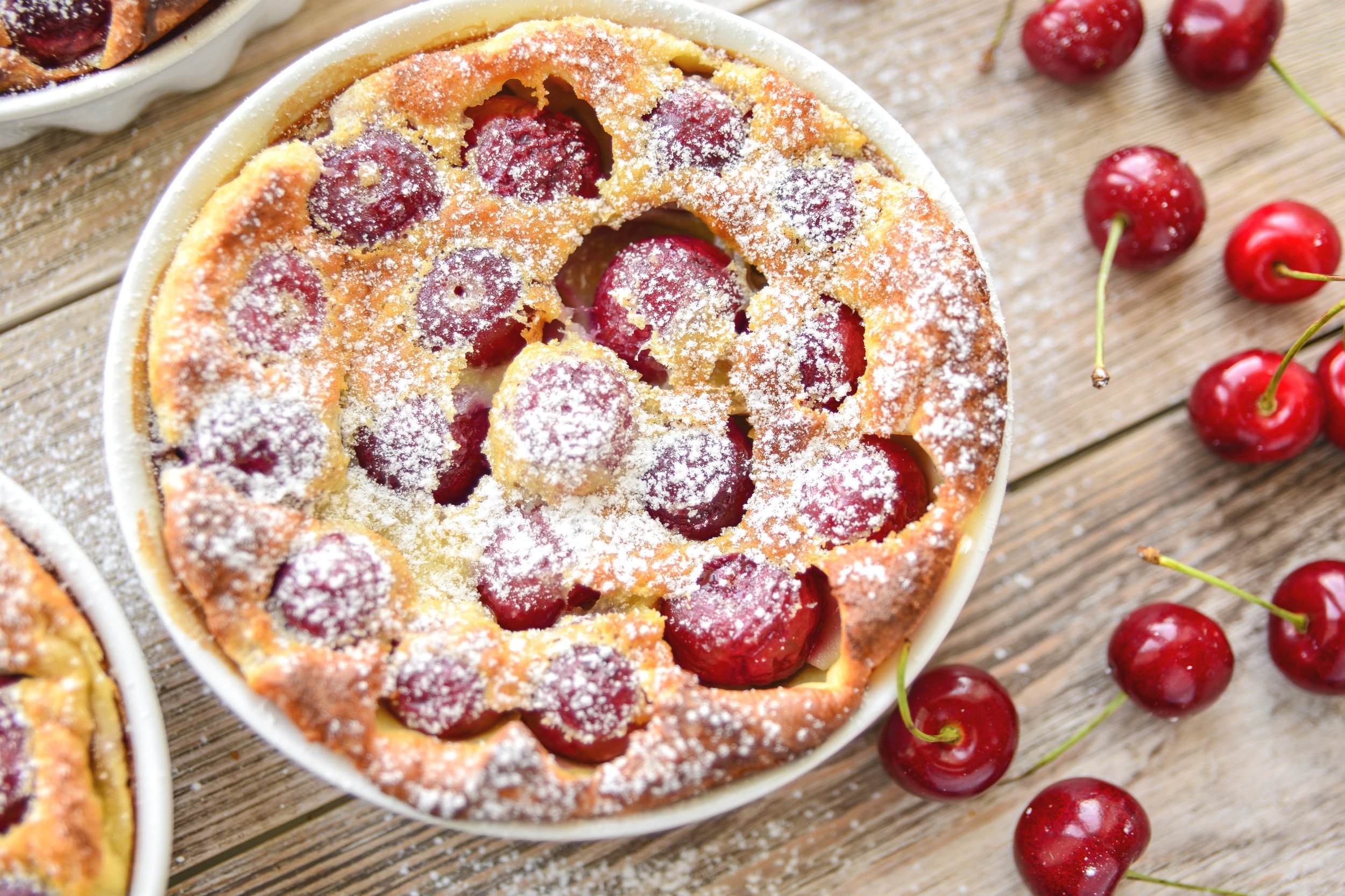 clafoutis with cherry in ceramic form - french tart with cherry