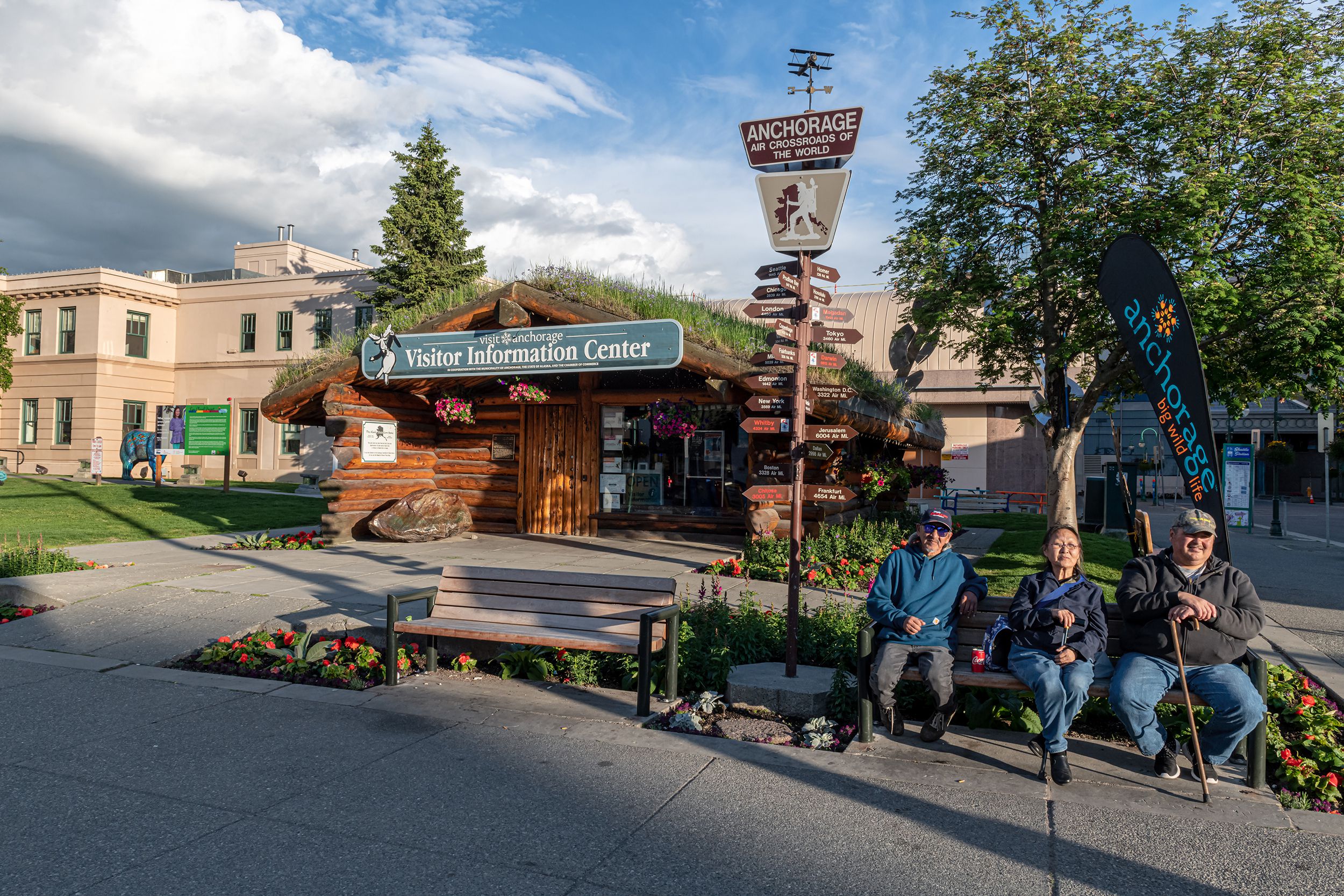 locals pose for photo on park bench near the visitor center, Anchorage Alaska