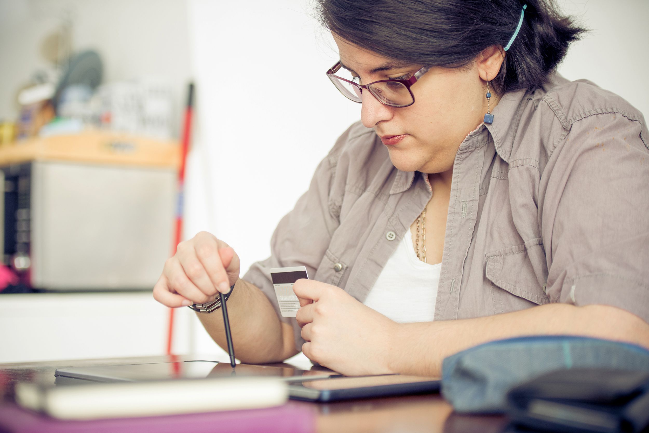 woman paying online with a credit card from home