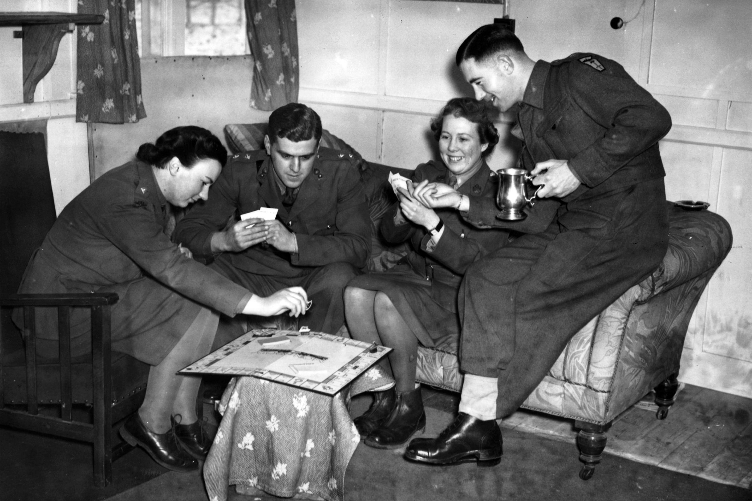 British Army and Auxiliary Territorial Services (ATS) officers enjoy a game of Monopoly