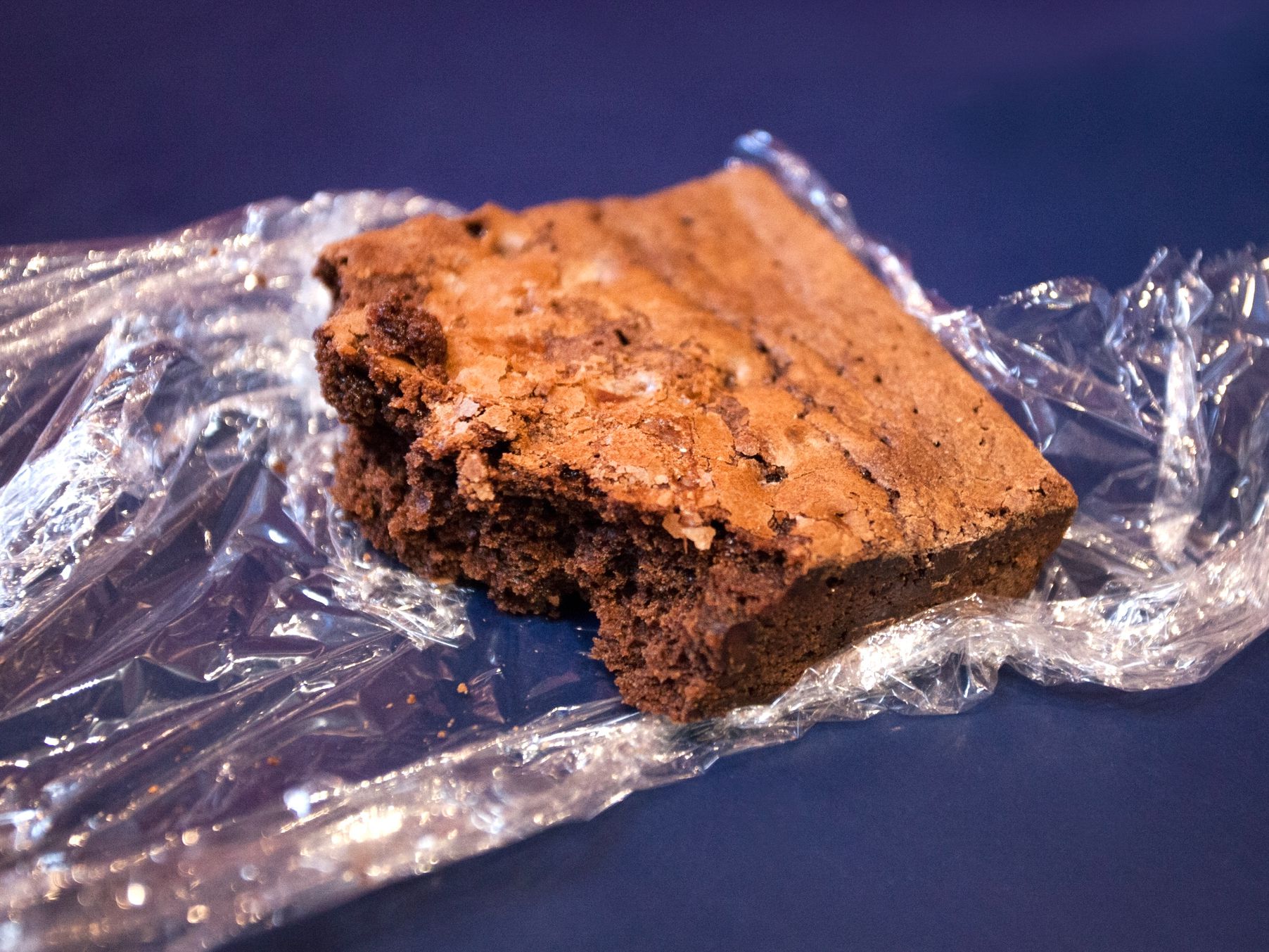 Partially eaten brown in plastic wrap. Horizontal