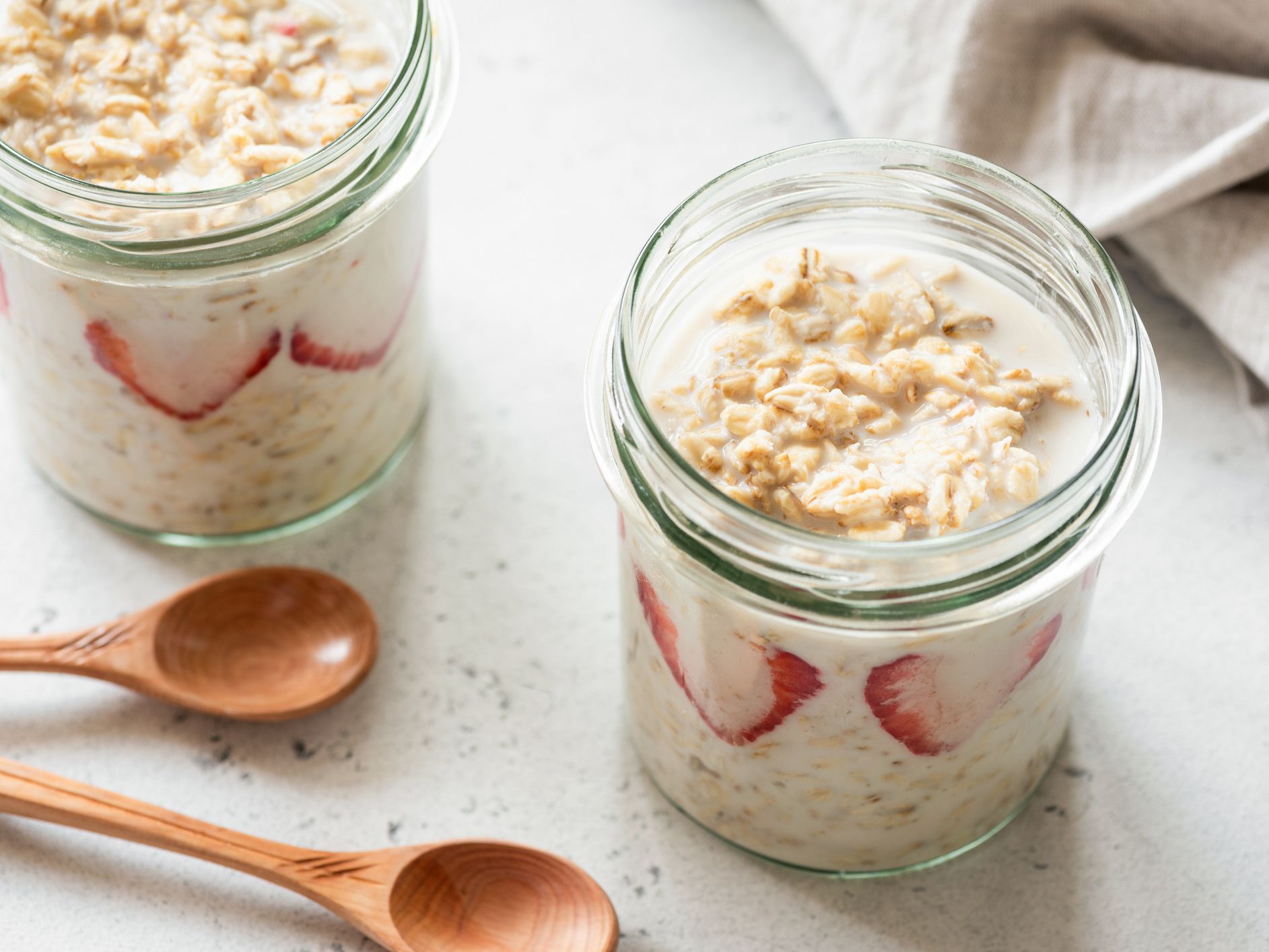 Overnight oats or oatmeal in a jar on concrete background. Healthy eating, healthy lifestyle concept