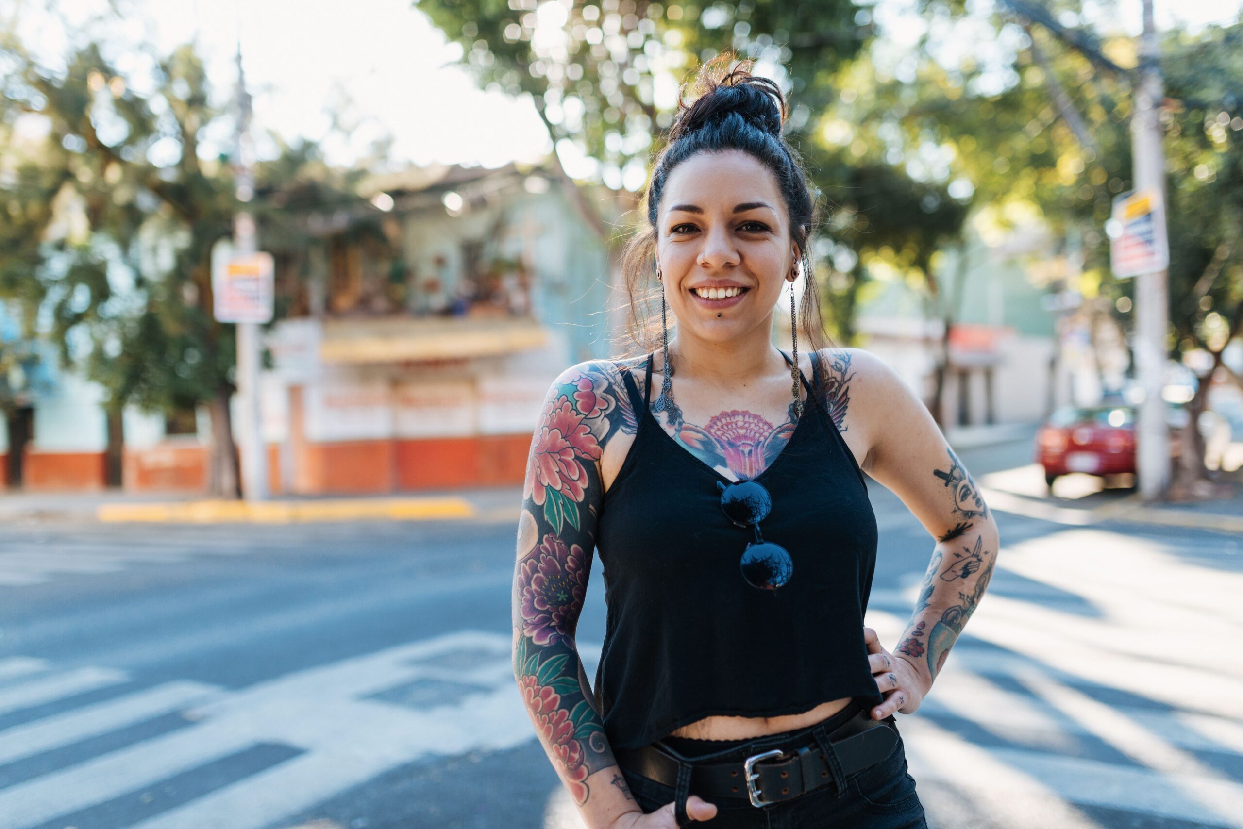 woman standing in street with tattoos