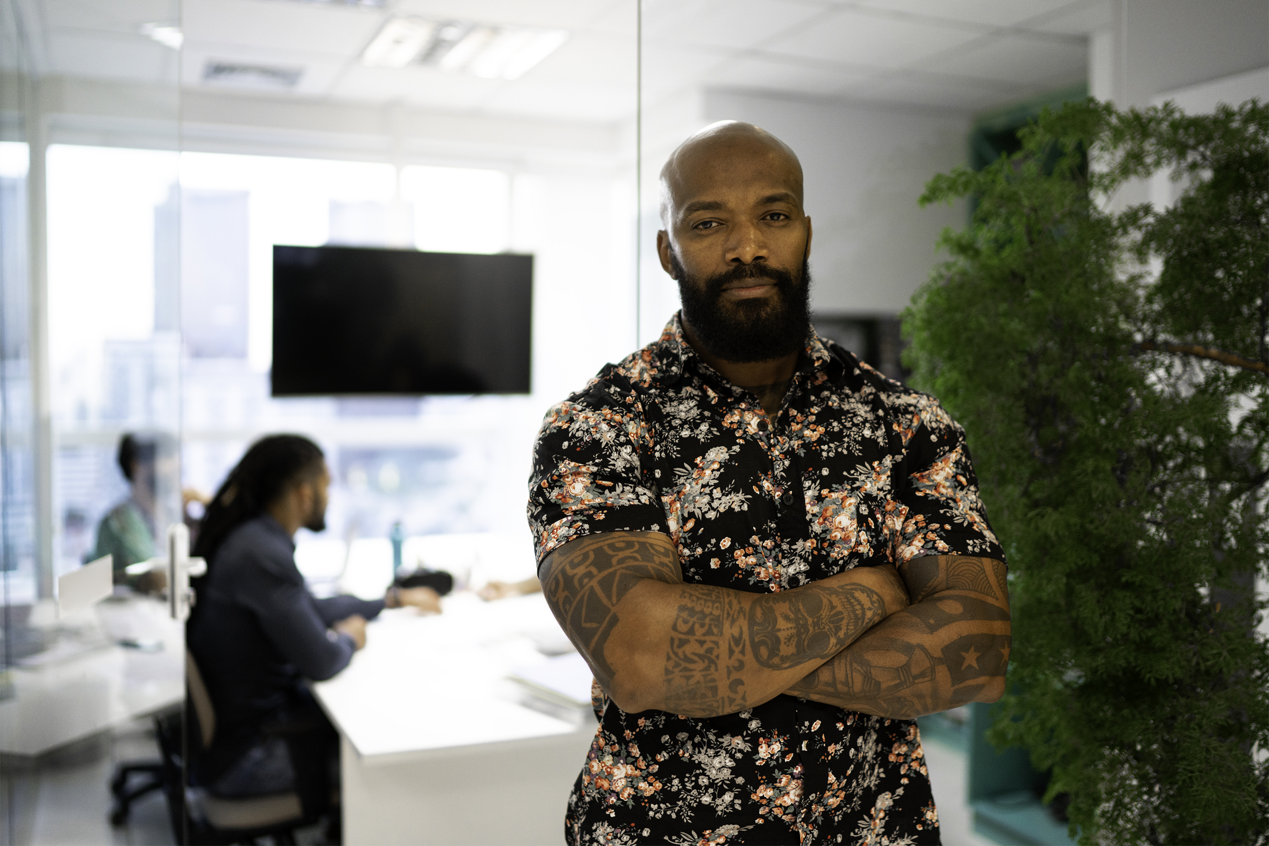 business man folding arms with tattoos