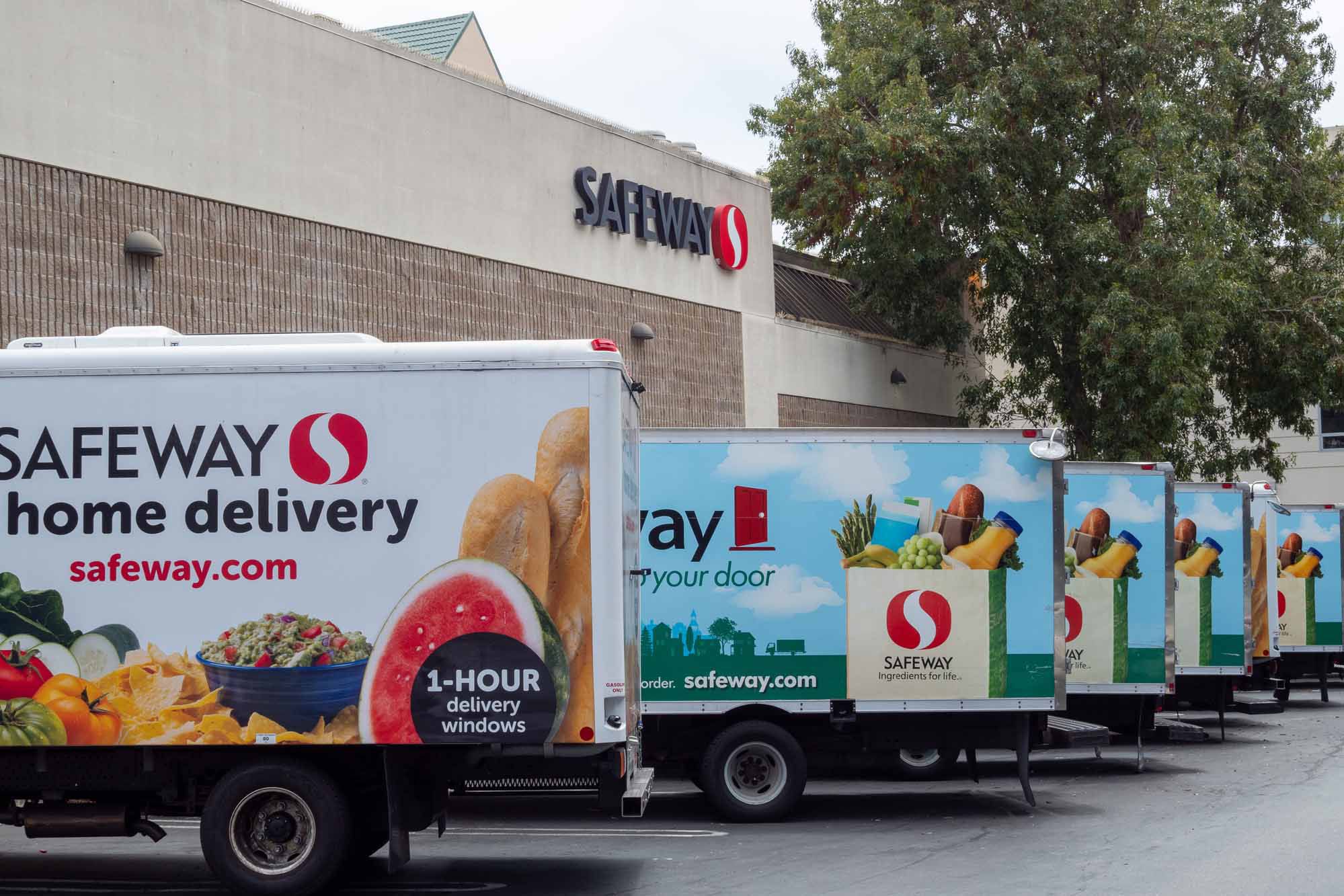San Francisco, CA JULY 29, 2018: Fleet of Safeway home grocery delivery trucks outside of store location