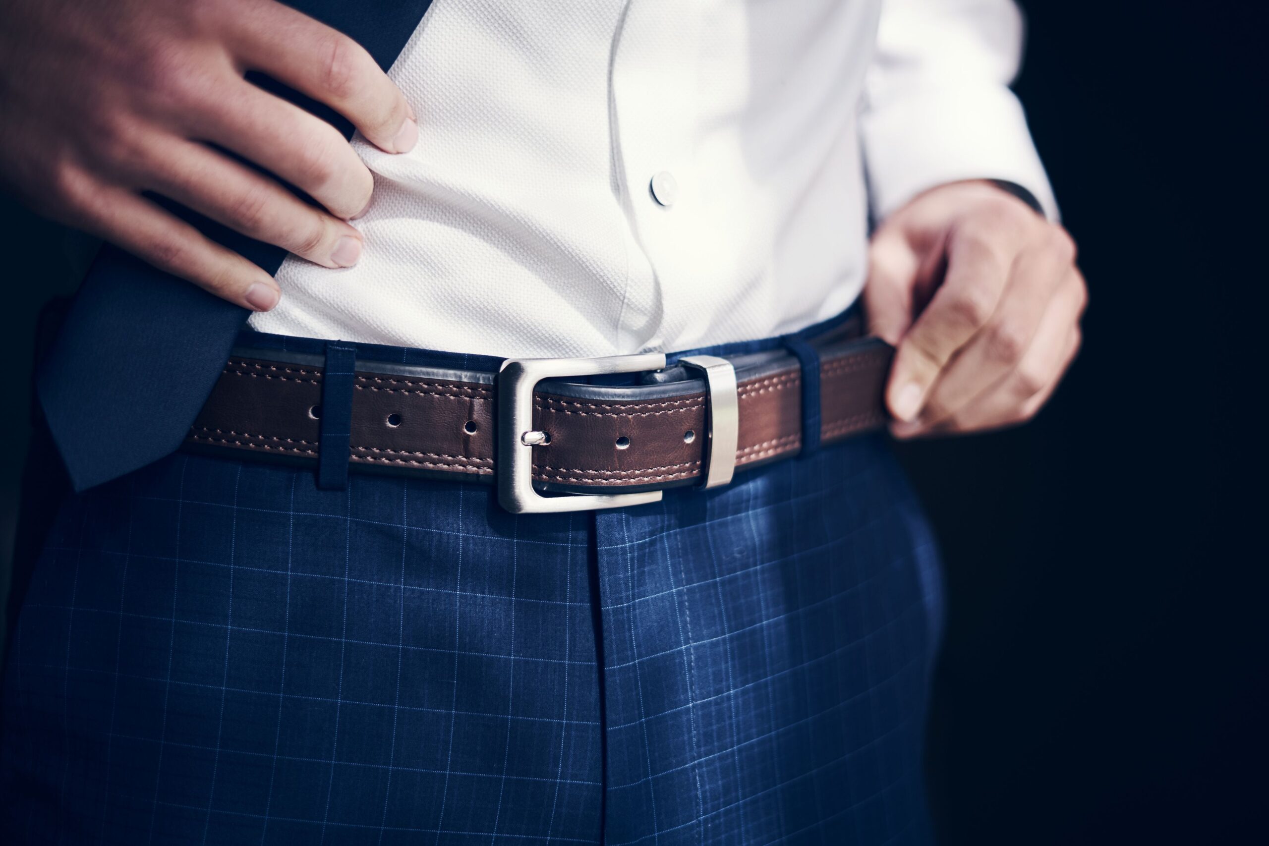 close up of business man wearing belt and suit