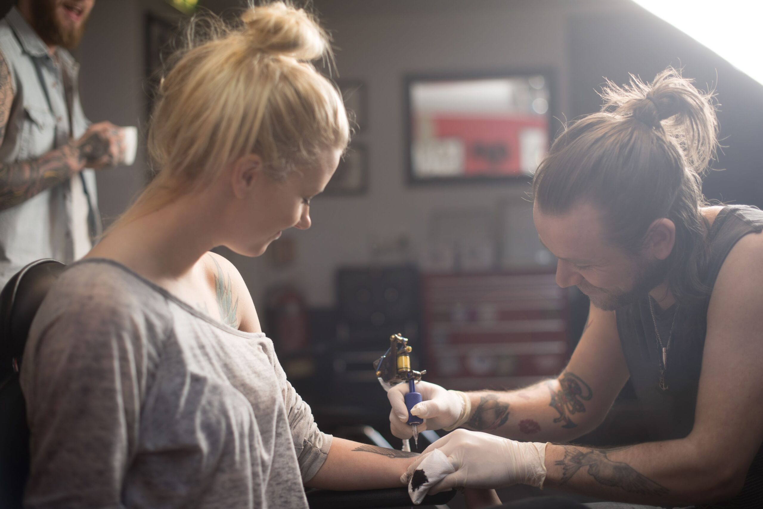 young woman getting a tattoo