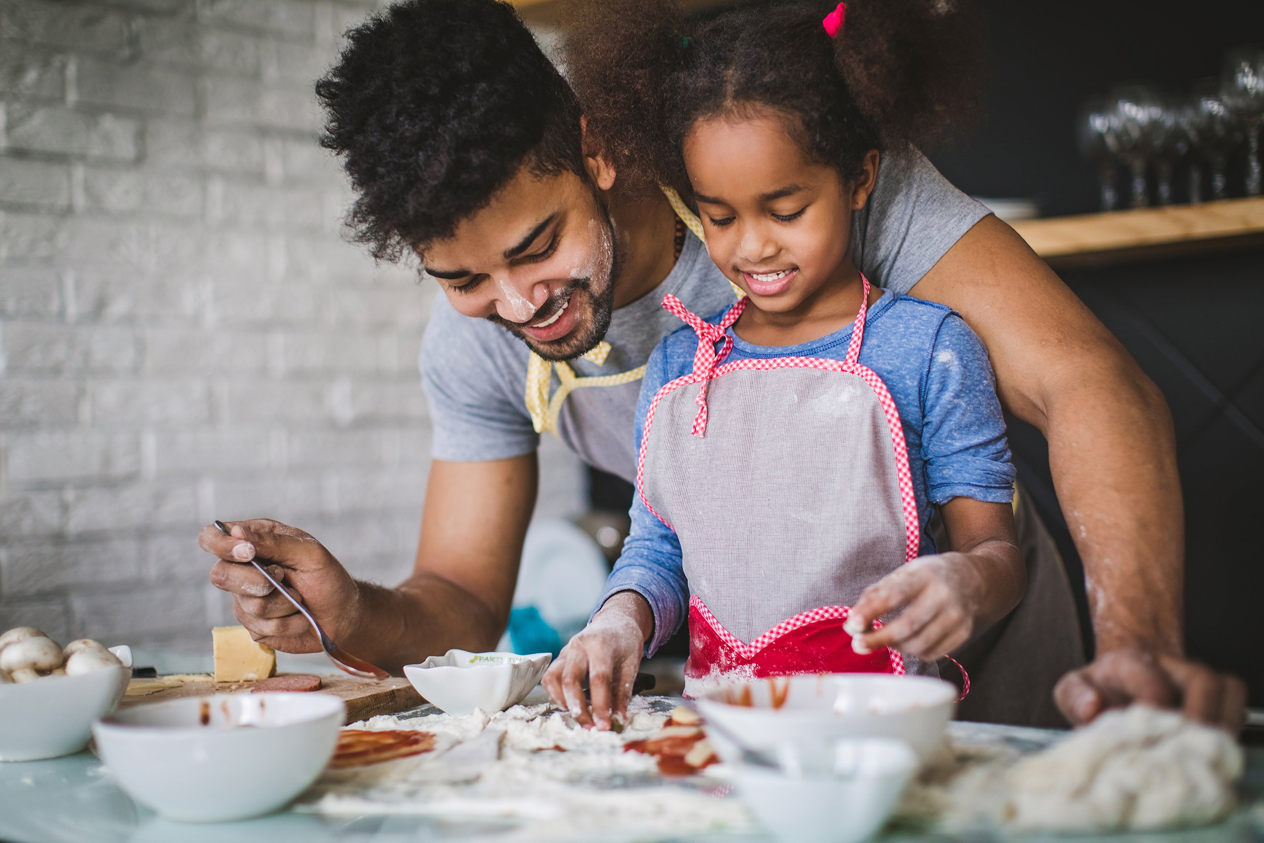 father and daughter cooking in kitchen