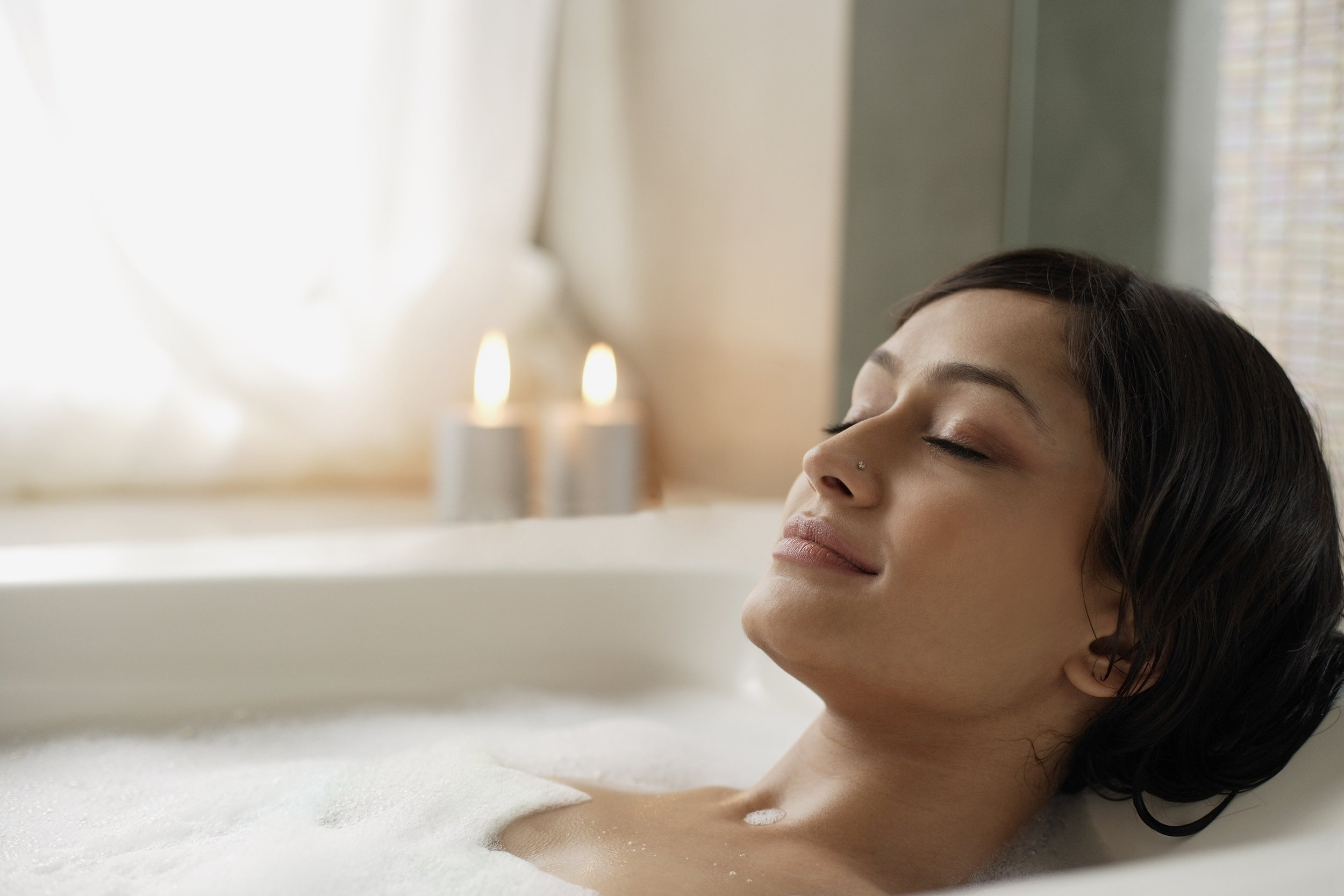 Asian Indian woman soaking in bath