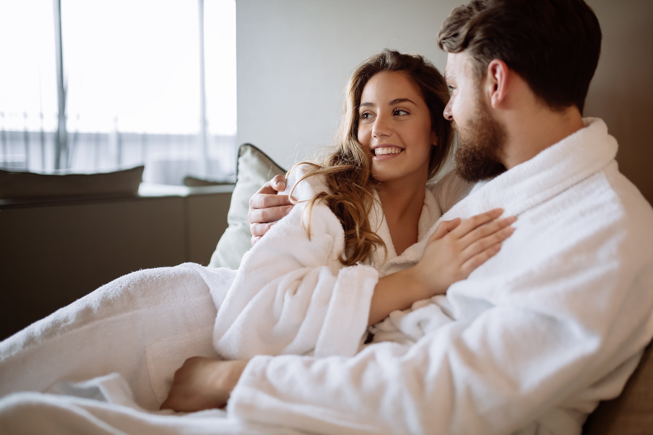 couple on couch wearing robes