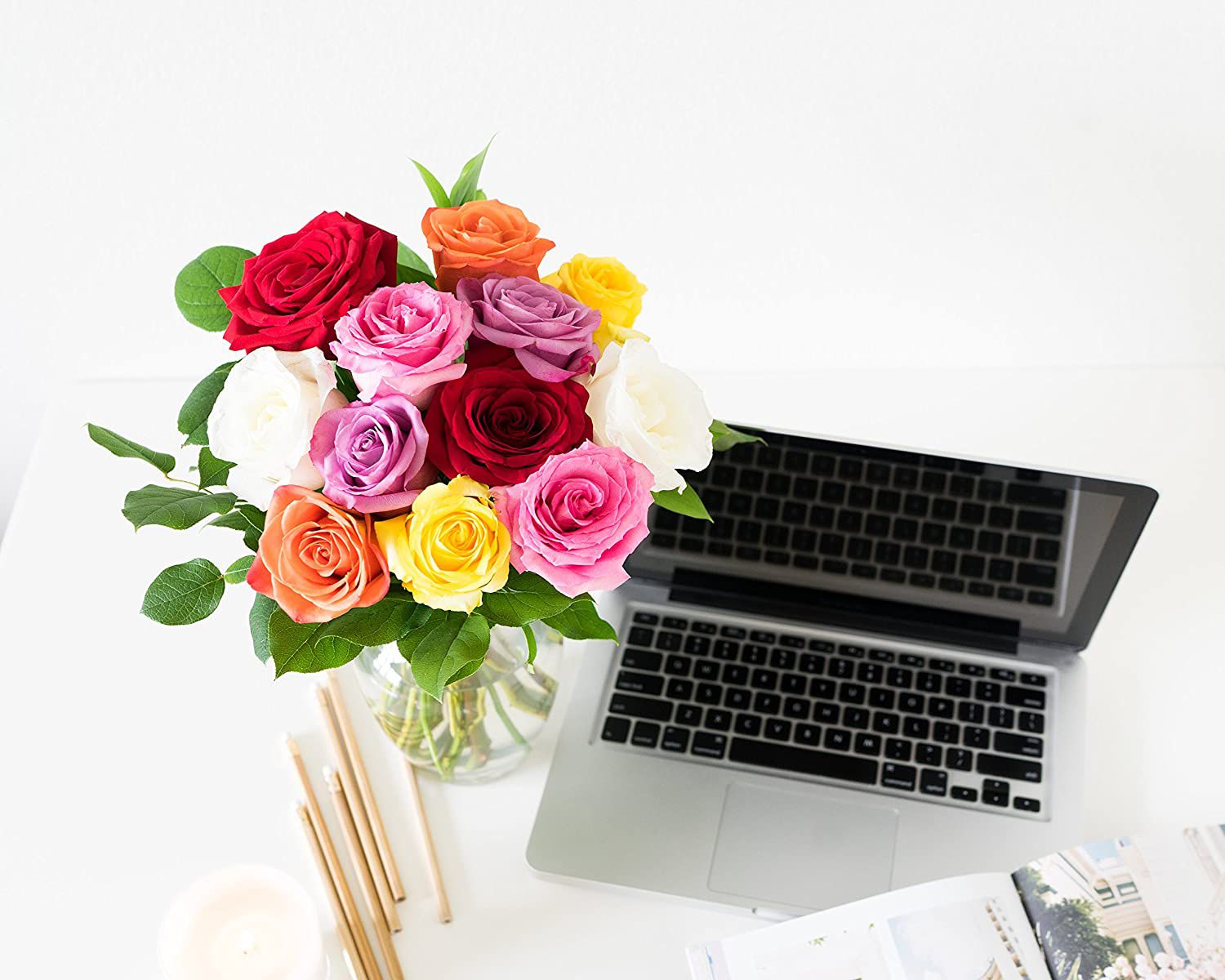 bouquet of flowers next to a laptop