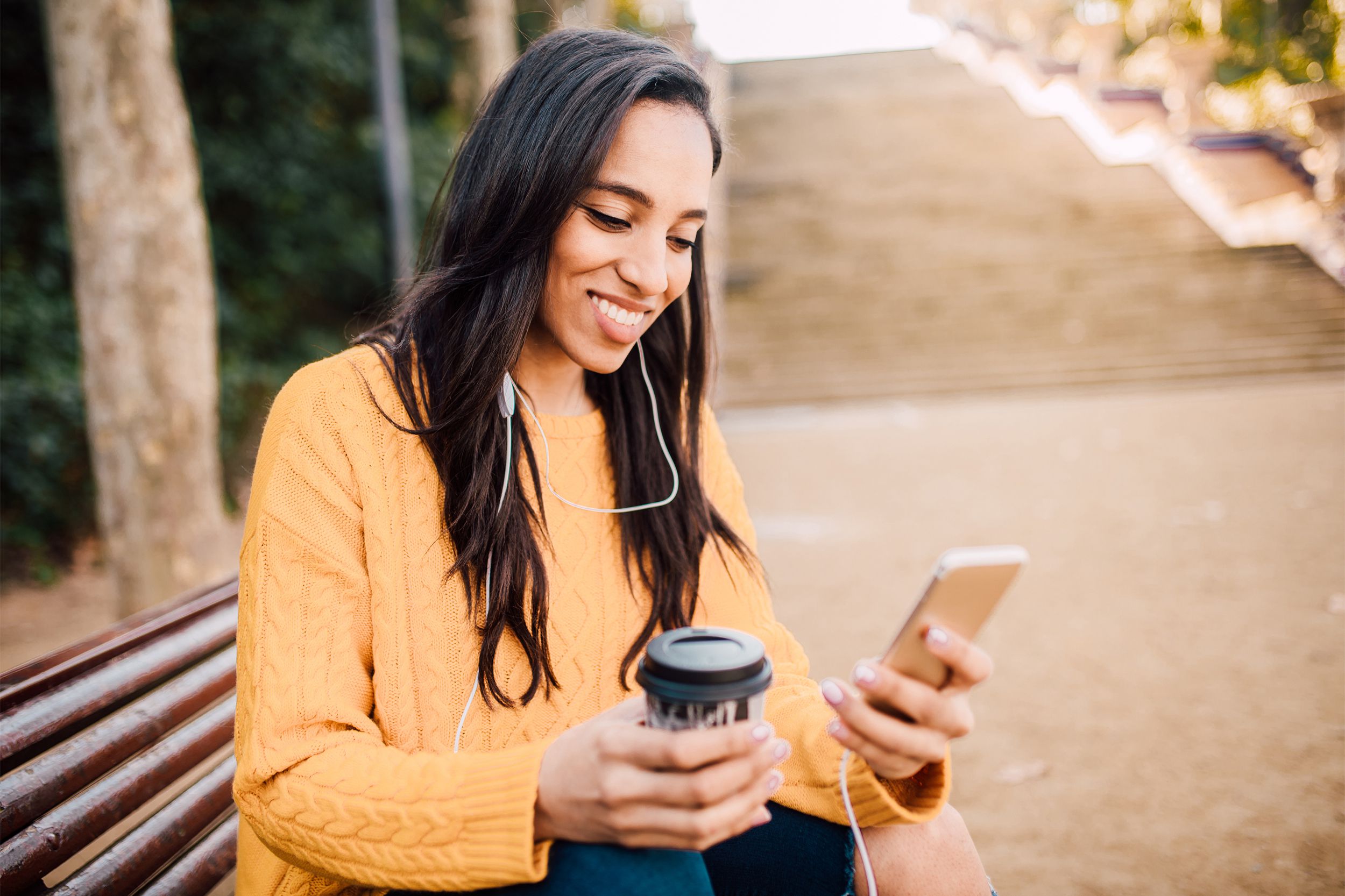 woman listening to phone outside