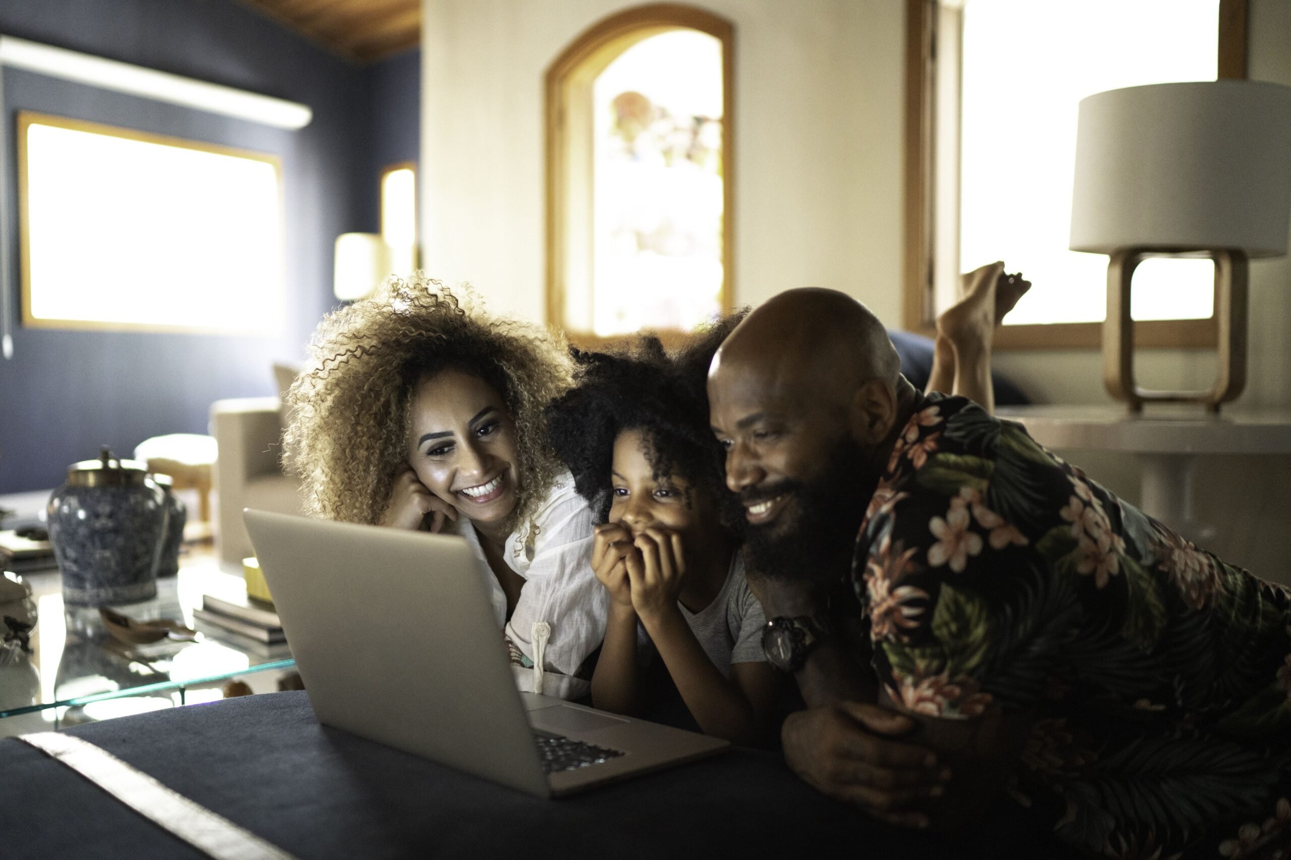 family looking at laptop