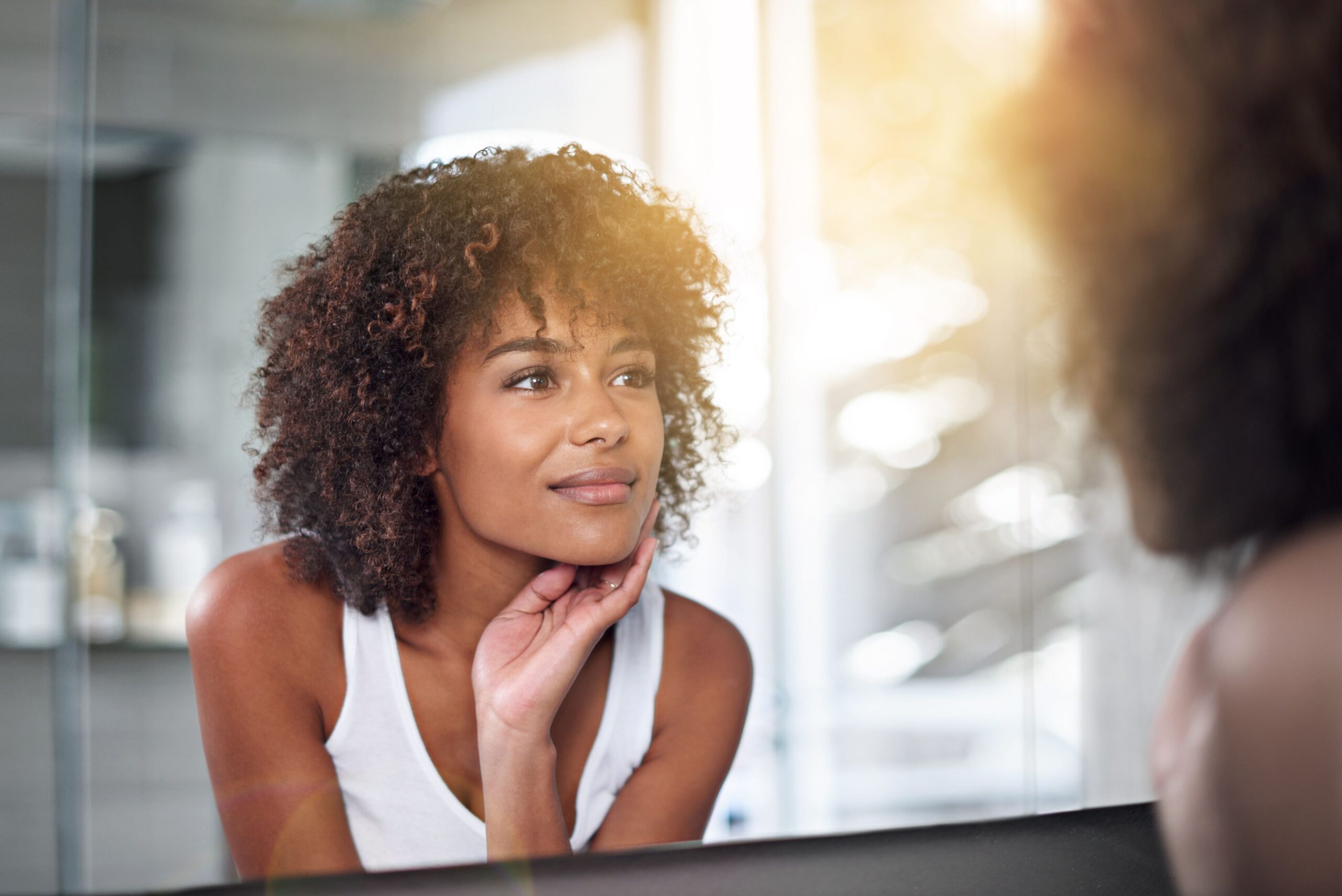 woman looking at self in mirror