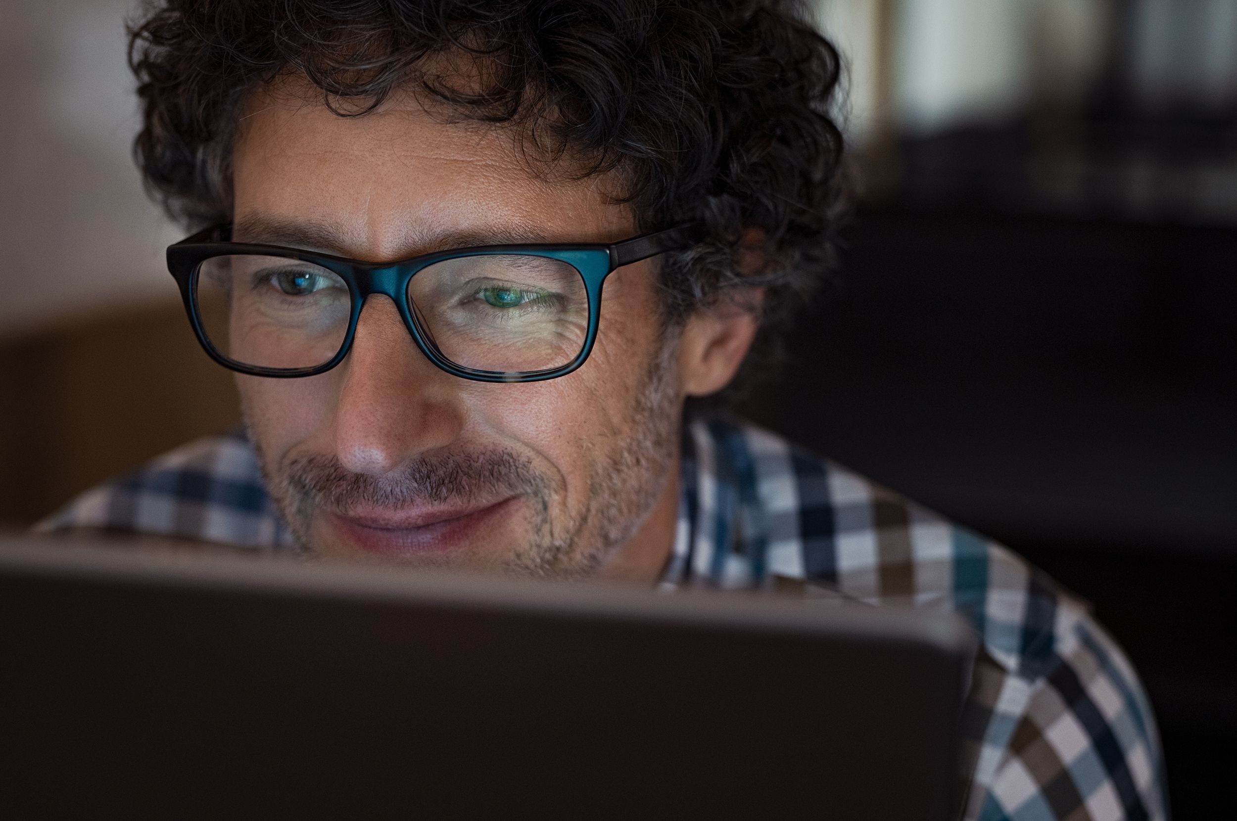 man working on laptop at night