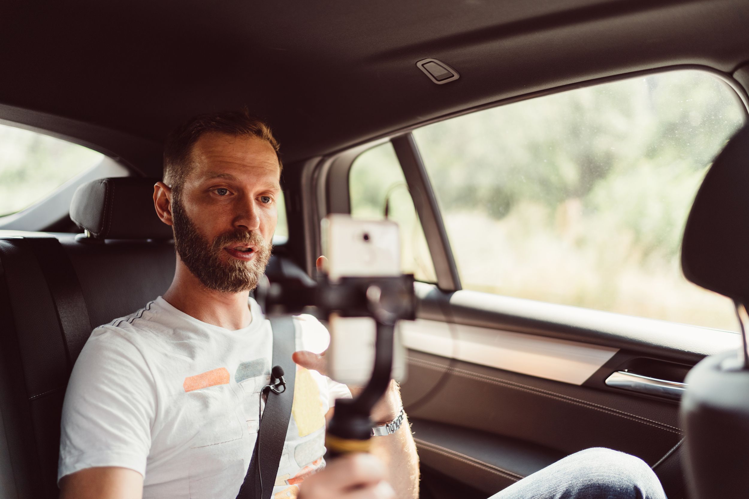 man vlogging in taxi
