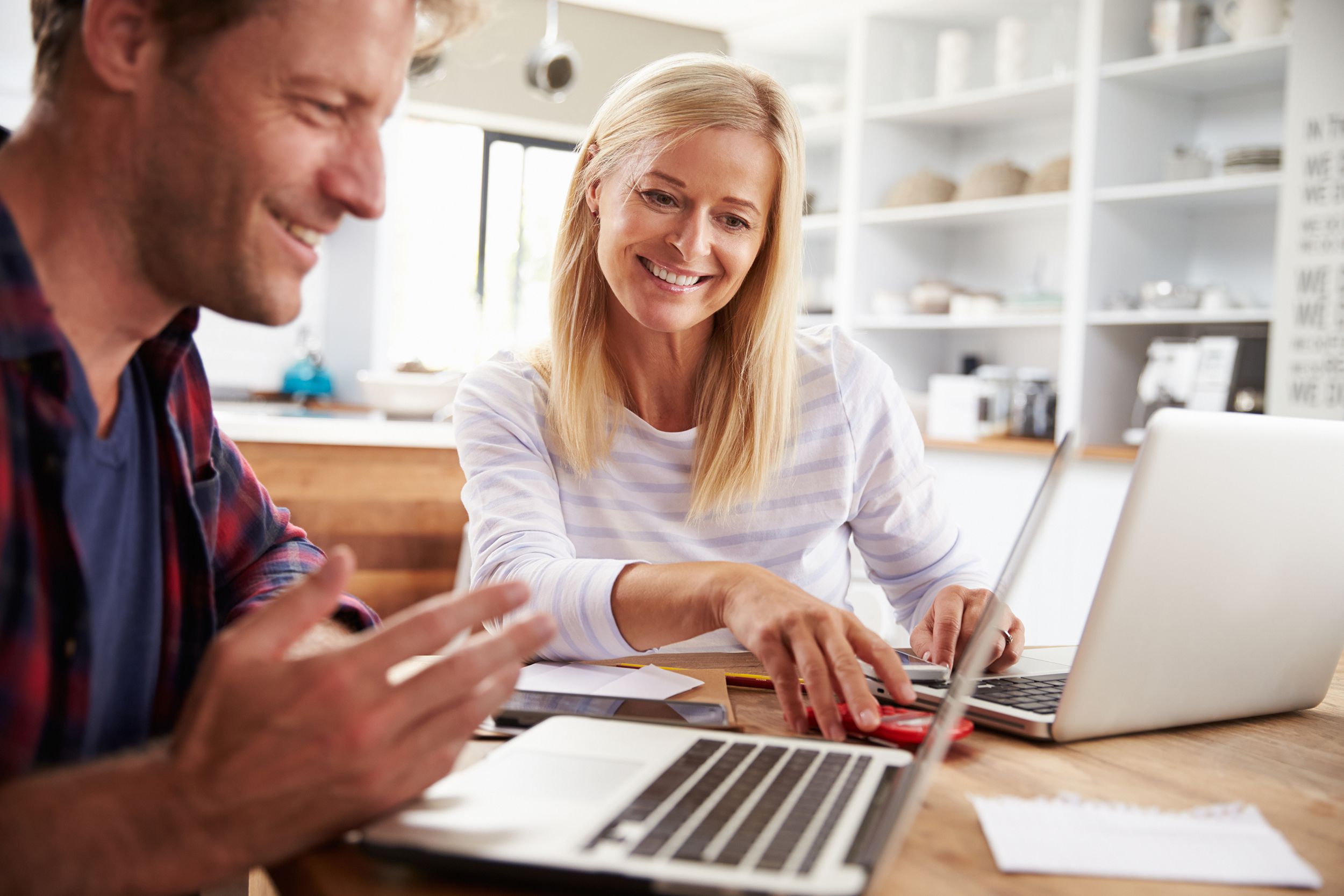 man and woman working together at home