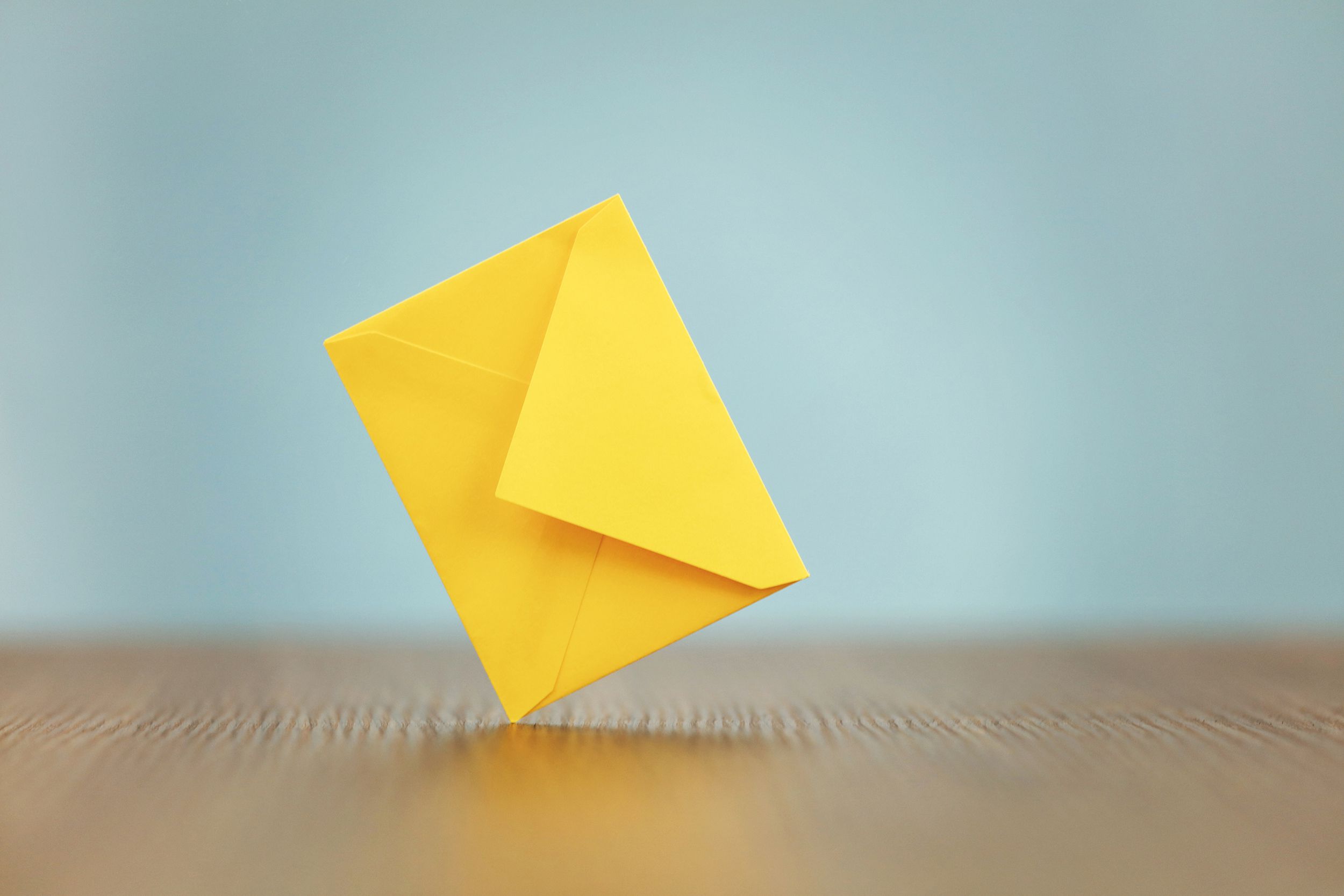 yellow envelope on table with light blue background