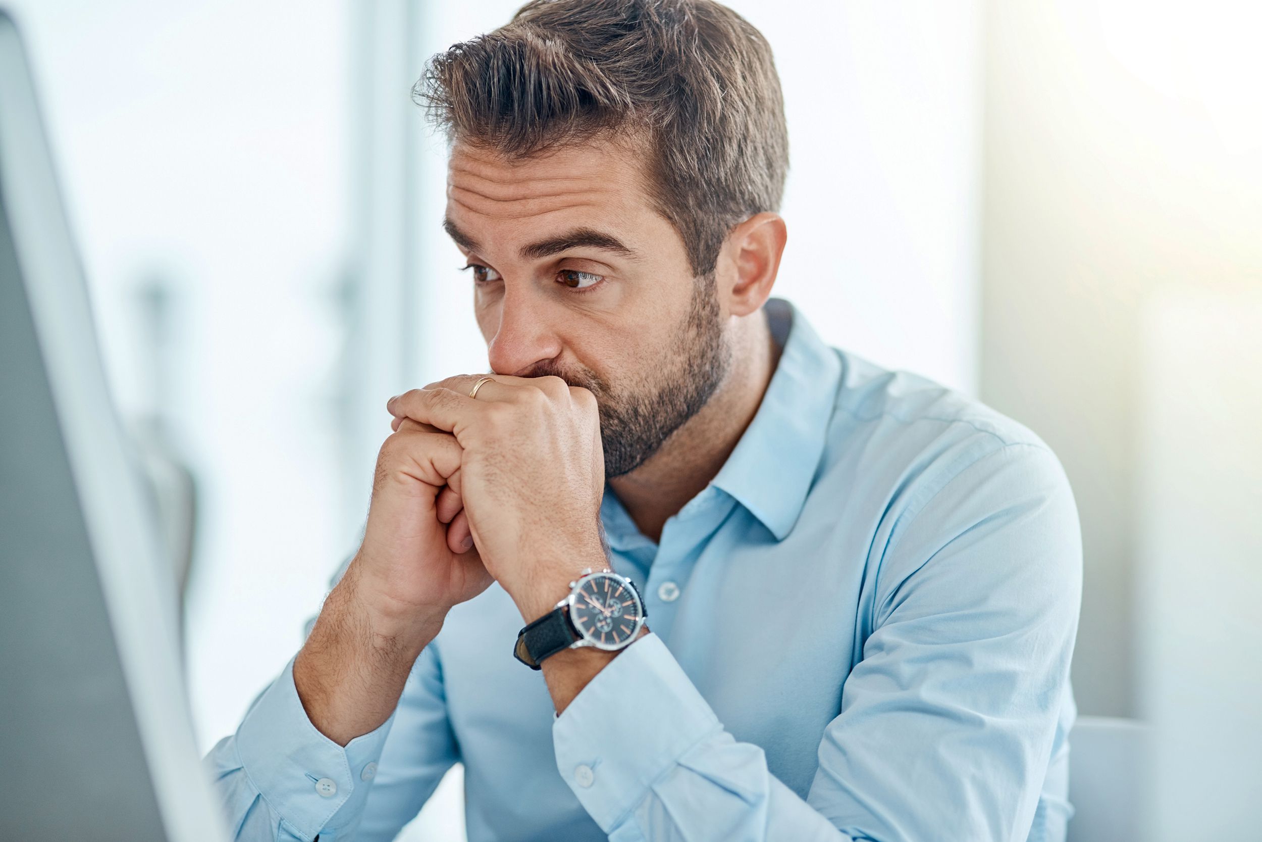 man sitting at his desk, worrying