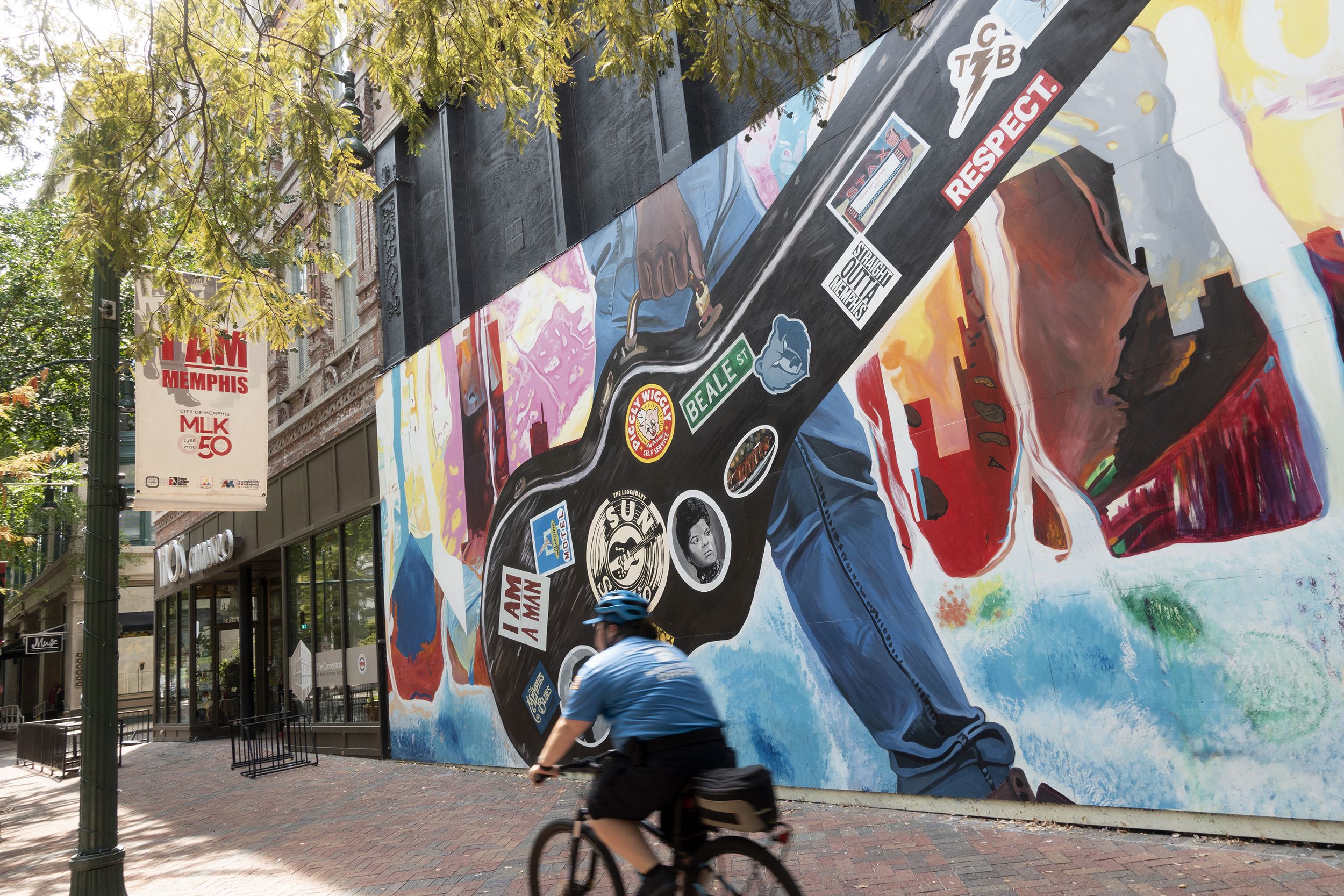 man biking past a mural in downtown Memphis, Tennessee