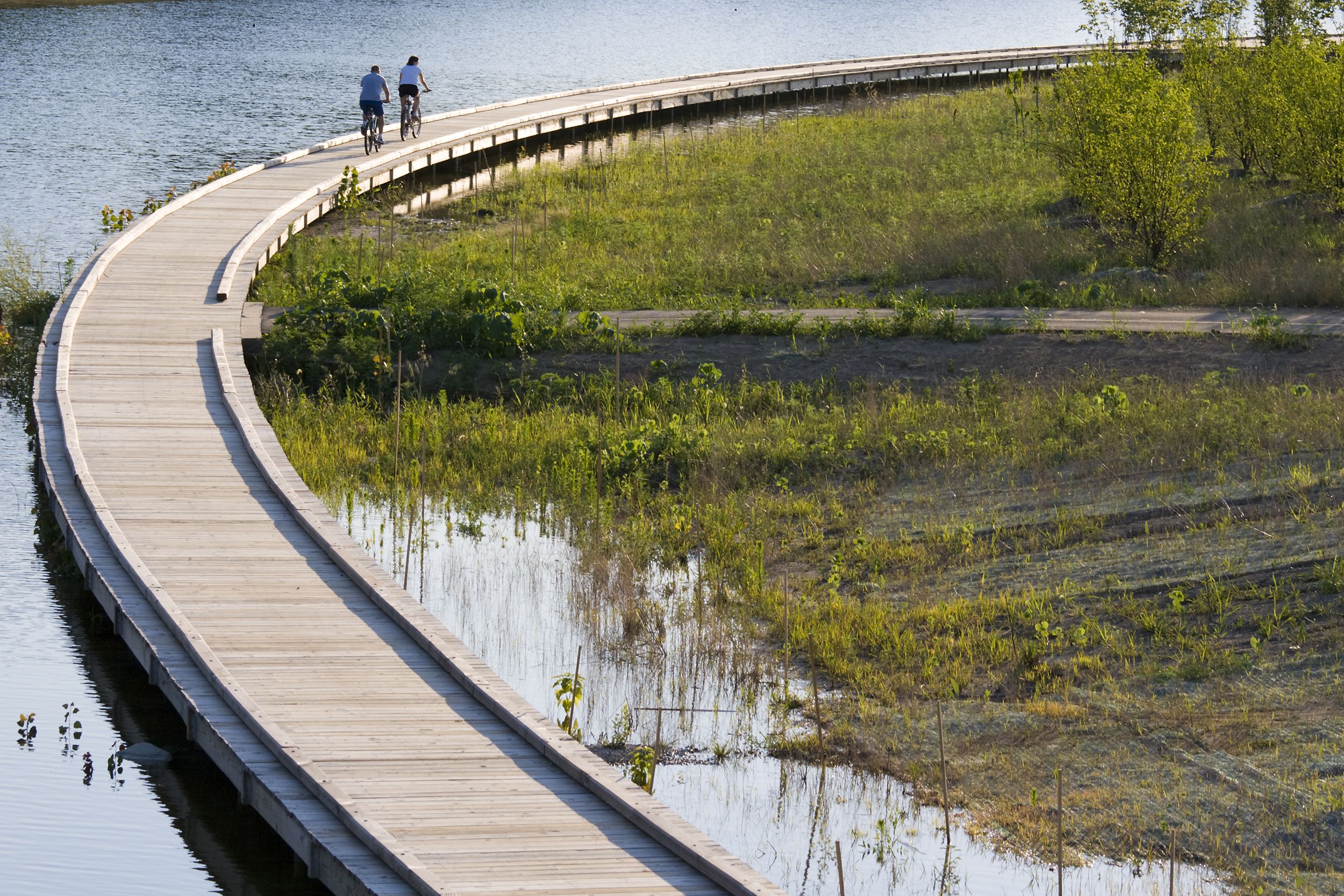 two people bicycling on boardwalk, Indianapolis, Indiana