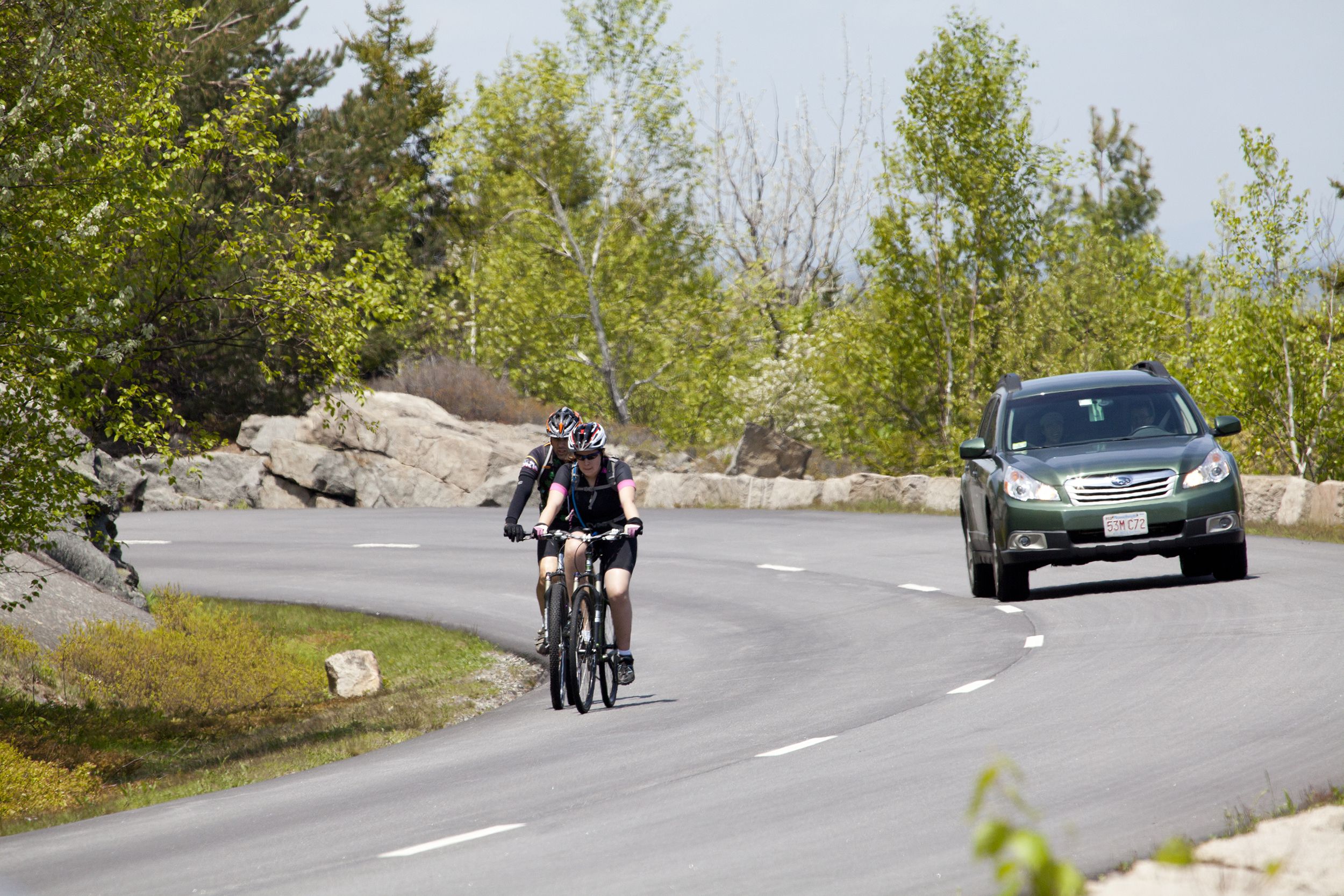 people were driving and riding bikes at the driveway at Acaida National Park, Maine
