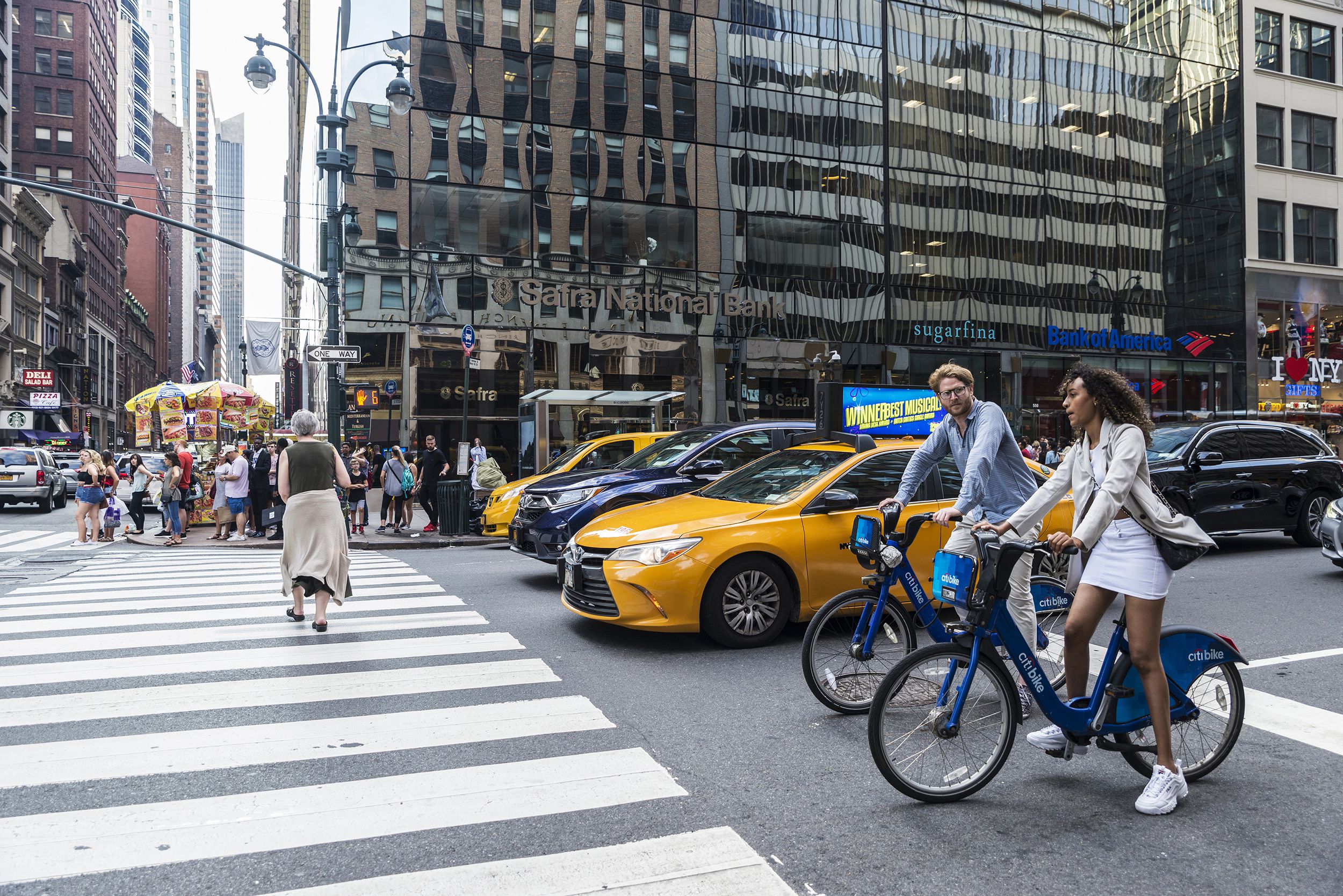 cyclists couple with Citibike bicycles on Fifth Avenue, Manhattan, New York City
