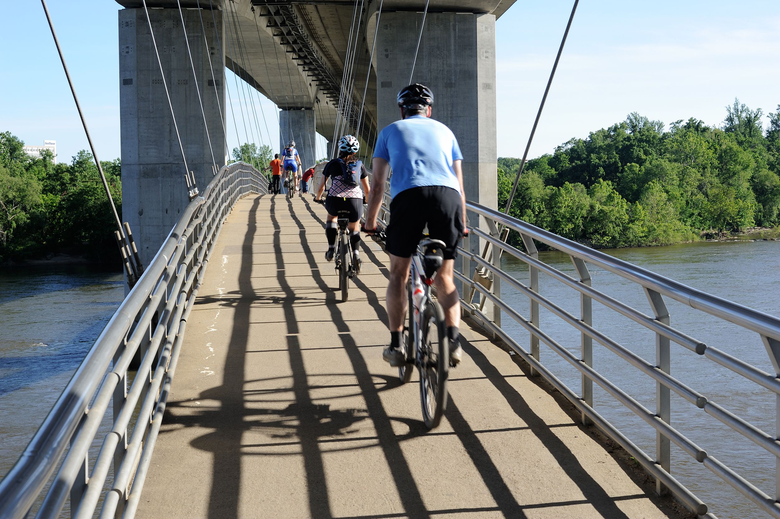 people biking on bridge over James River in Richmond, Virginia. Richmond