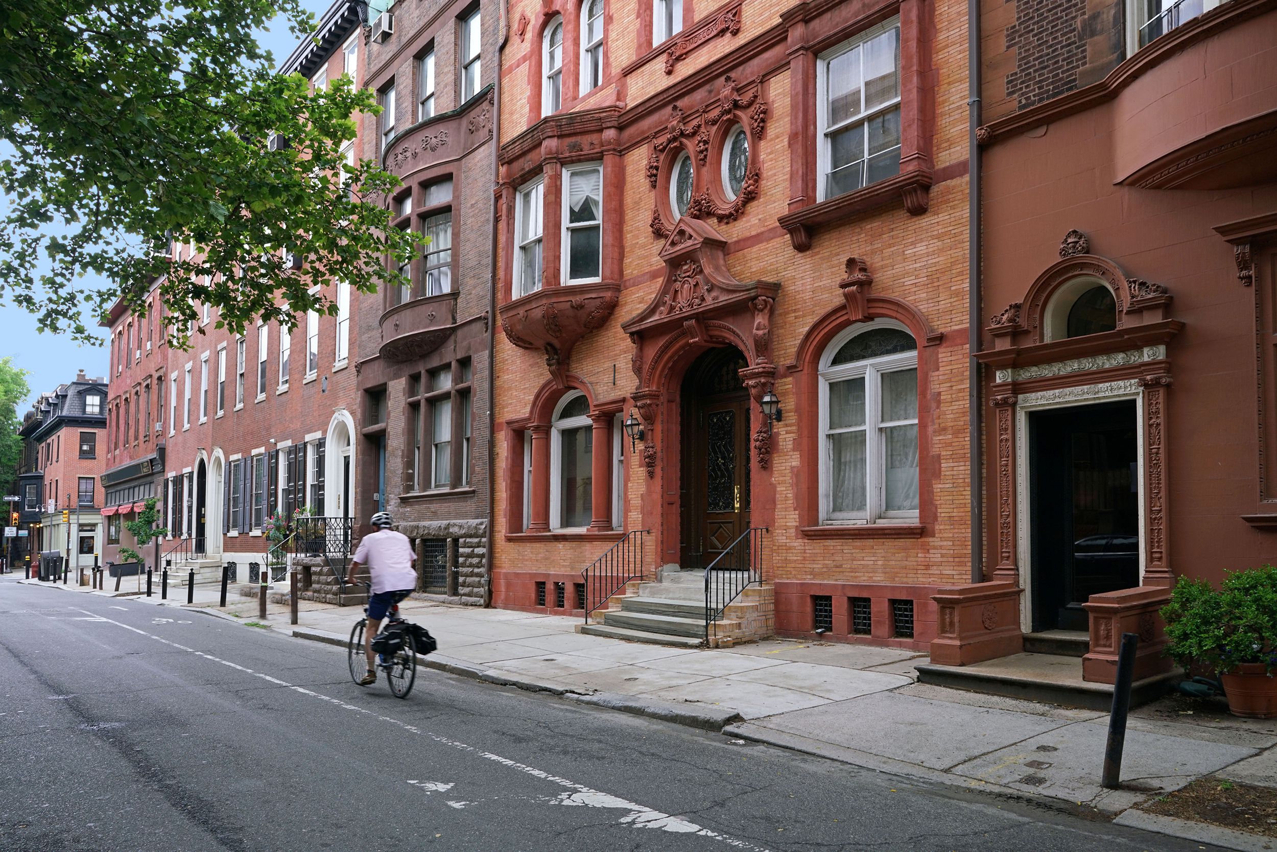 person biking along brownstone style townhouses, Boston, Massachusetts