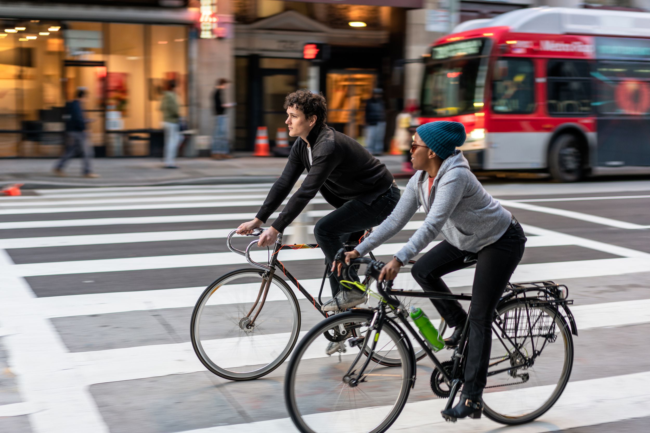 two friends cycling together in downtown Los Angeles