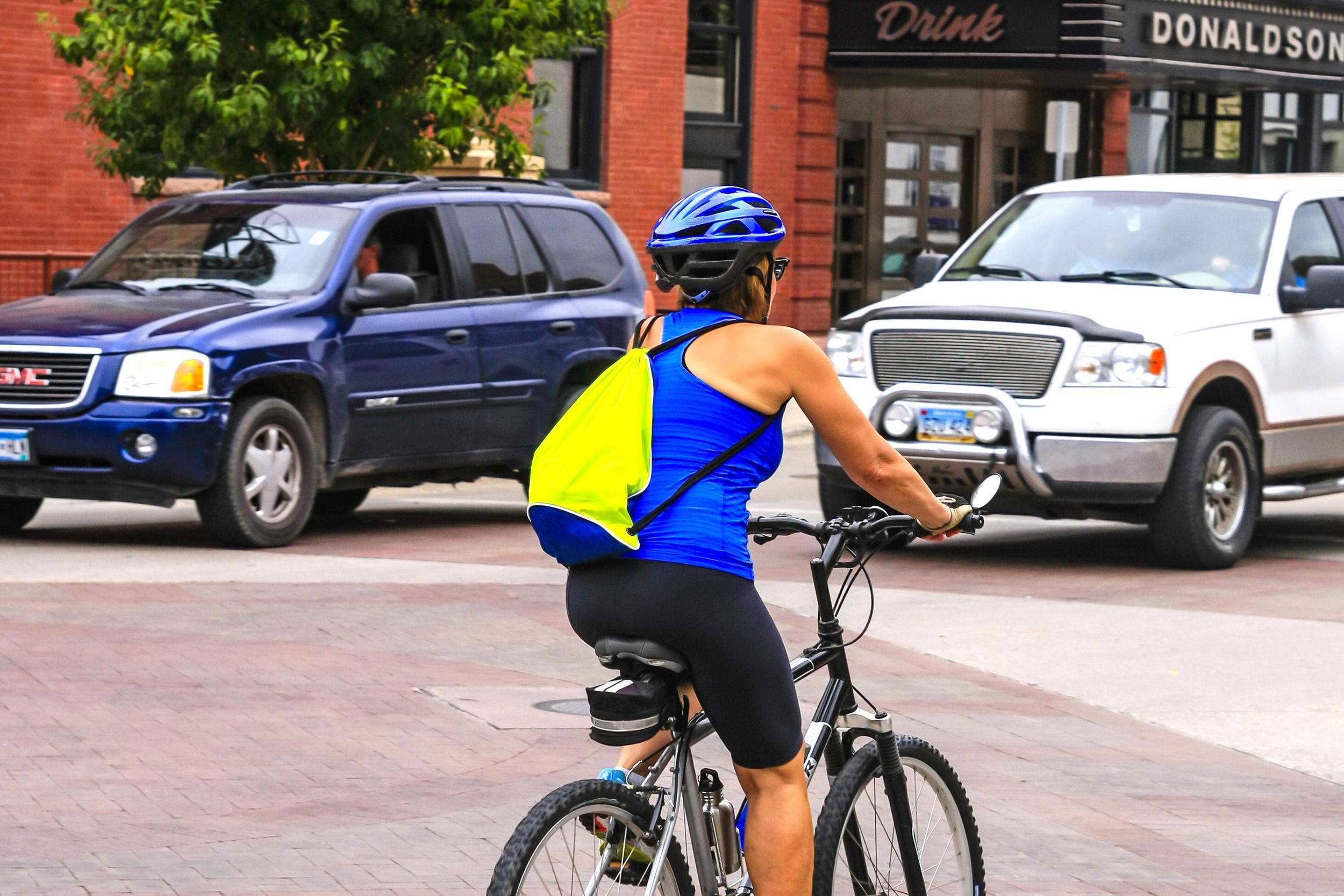 woman exercising by riding her bicycle on the streets of Fargo, North Dakota