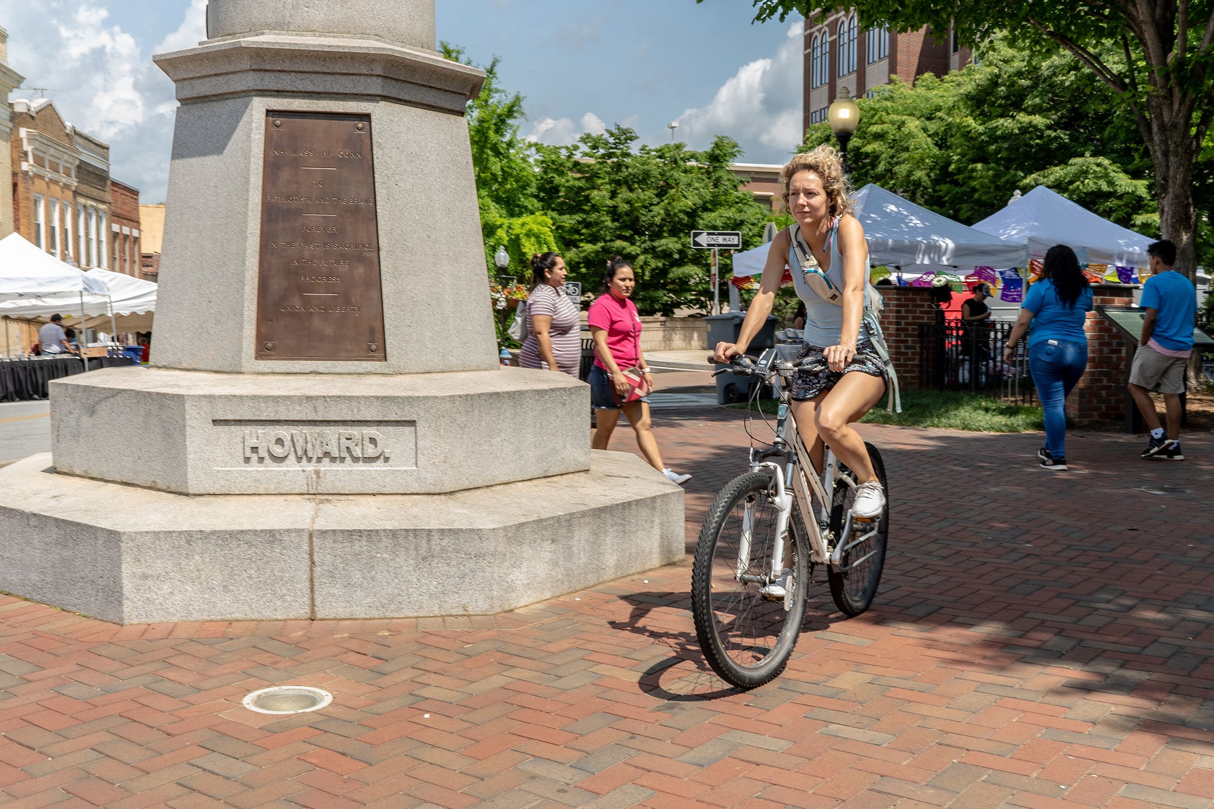 young woman rides a bicycle in Morgan Square, Spartanburg, South Carolina