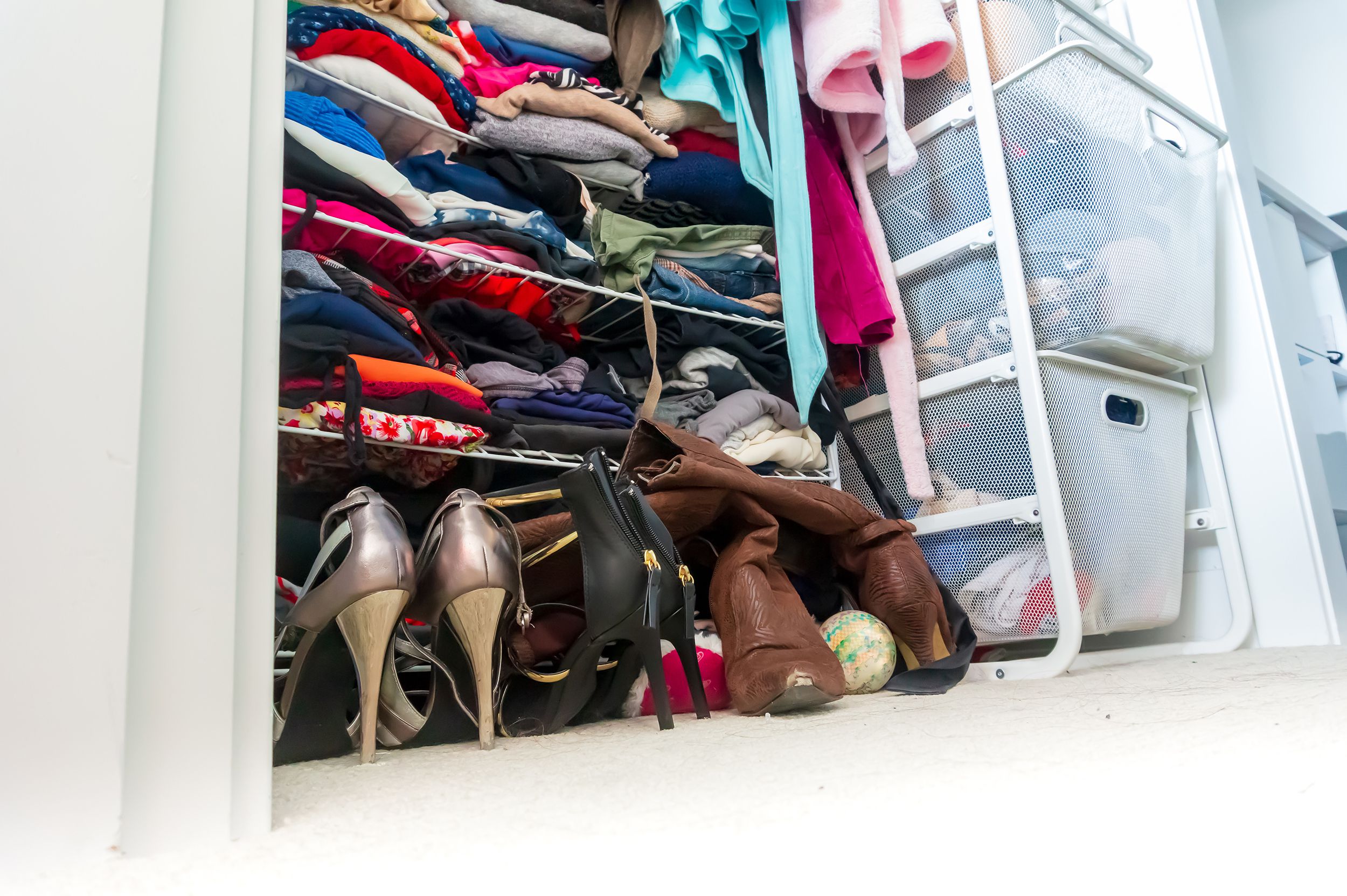 apartment closet organized and filled with woman's clothe