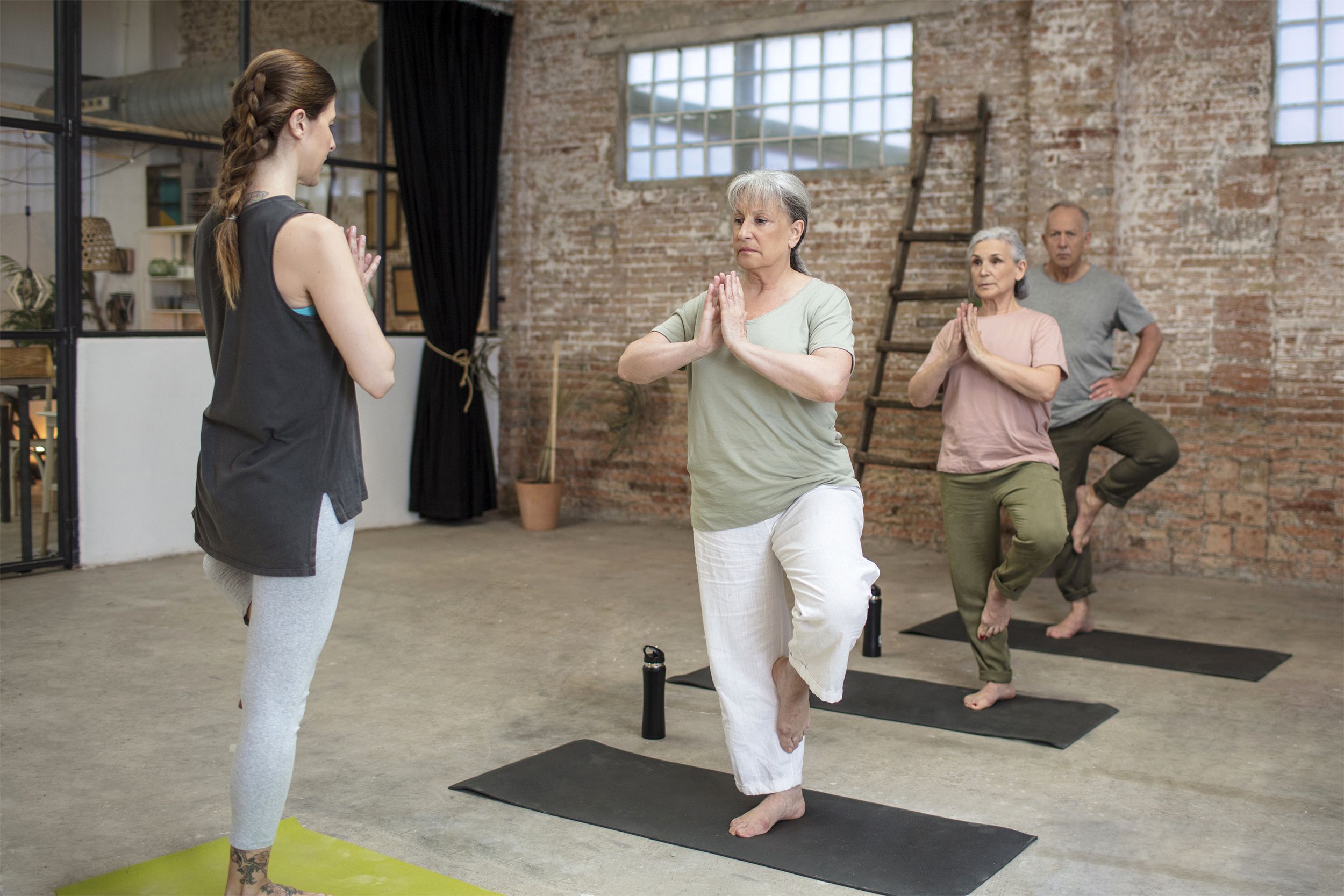 Group of older adults doing yoga and balance training