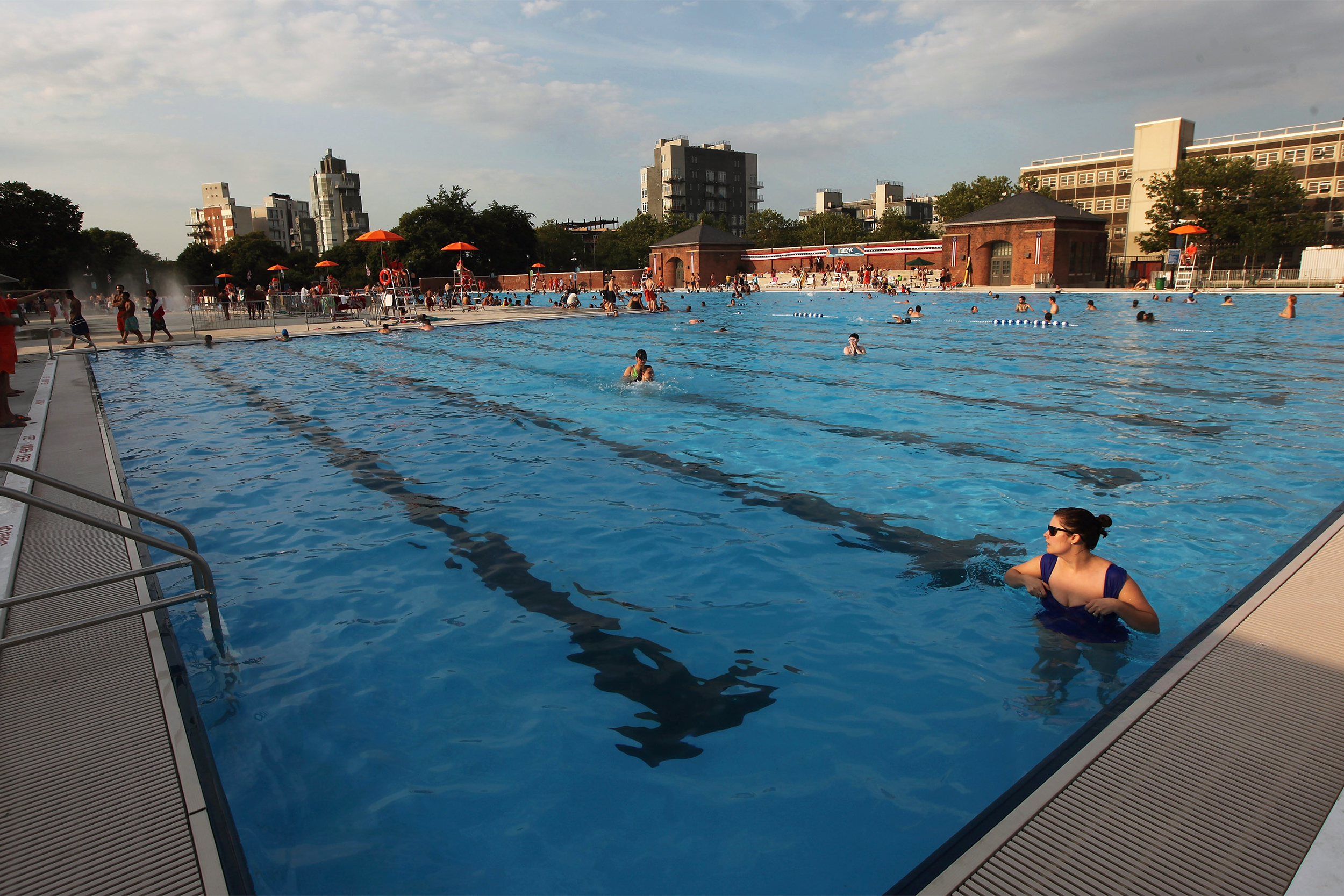 People bathe on opening day of the newly renovated McCarren Park Pool on June 28, 2012 in the Brooklyn borough of New York City.