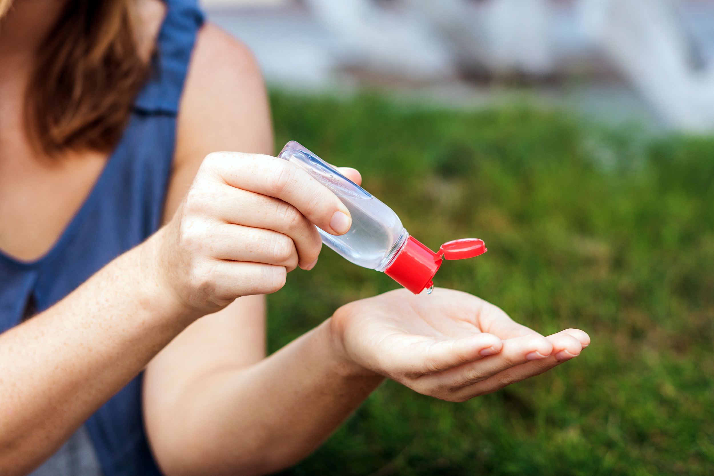 Woman using hand sanitizer