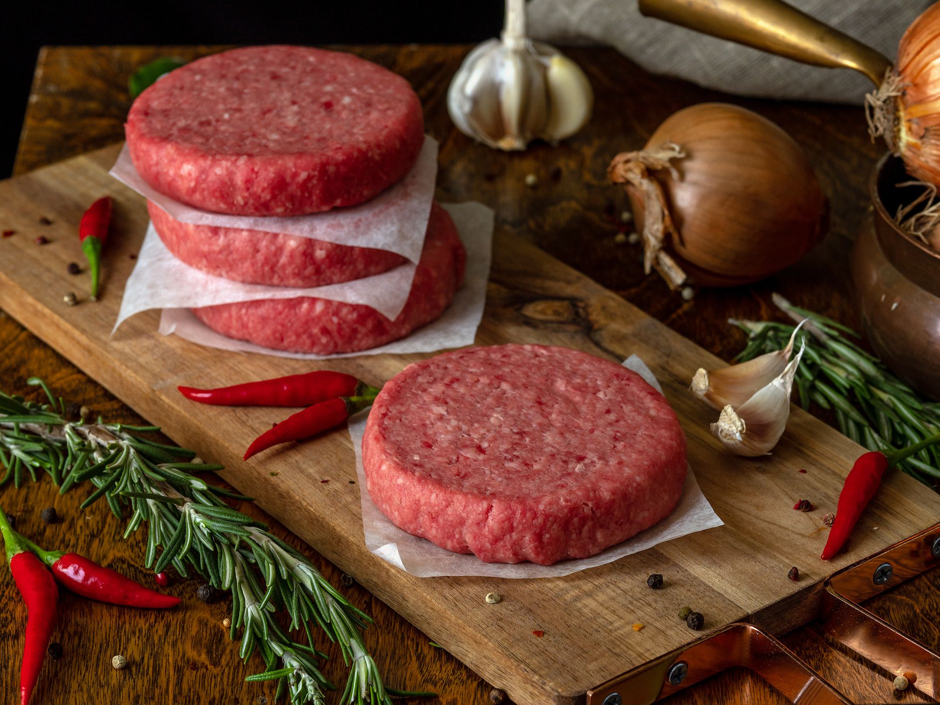 Raw beef burger, traditional barbecue, still life with vegetables and meat