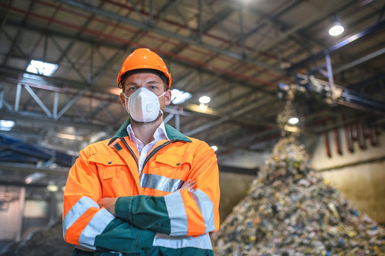 Serious Male Worker in Protective Gear at Waste Facility