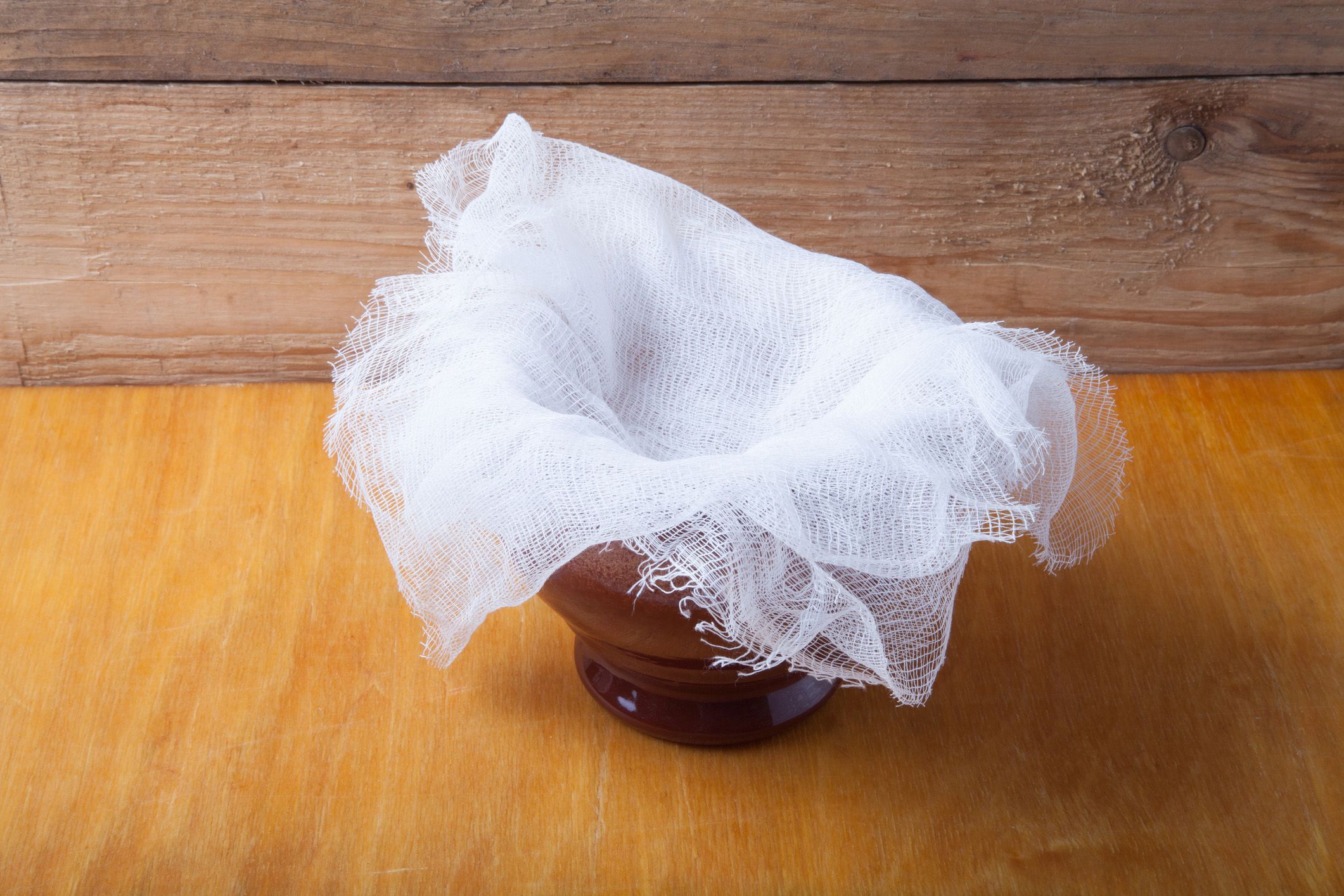 cheesecloth in clay bowl