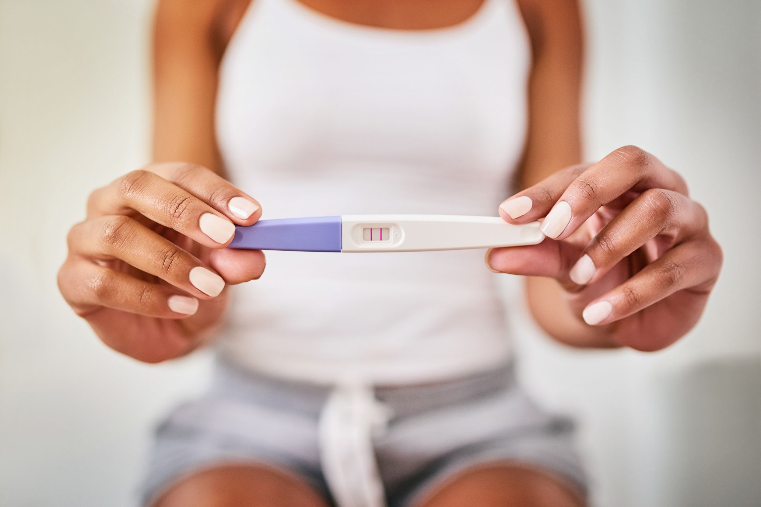 hands holding pregnancy test