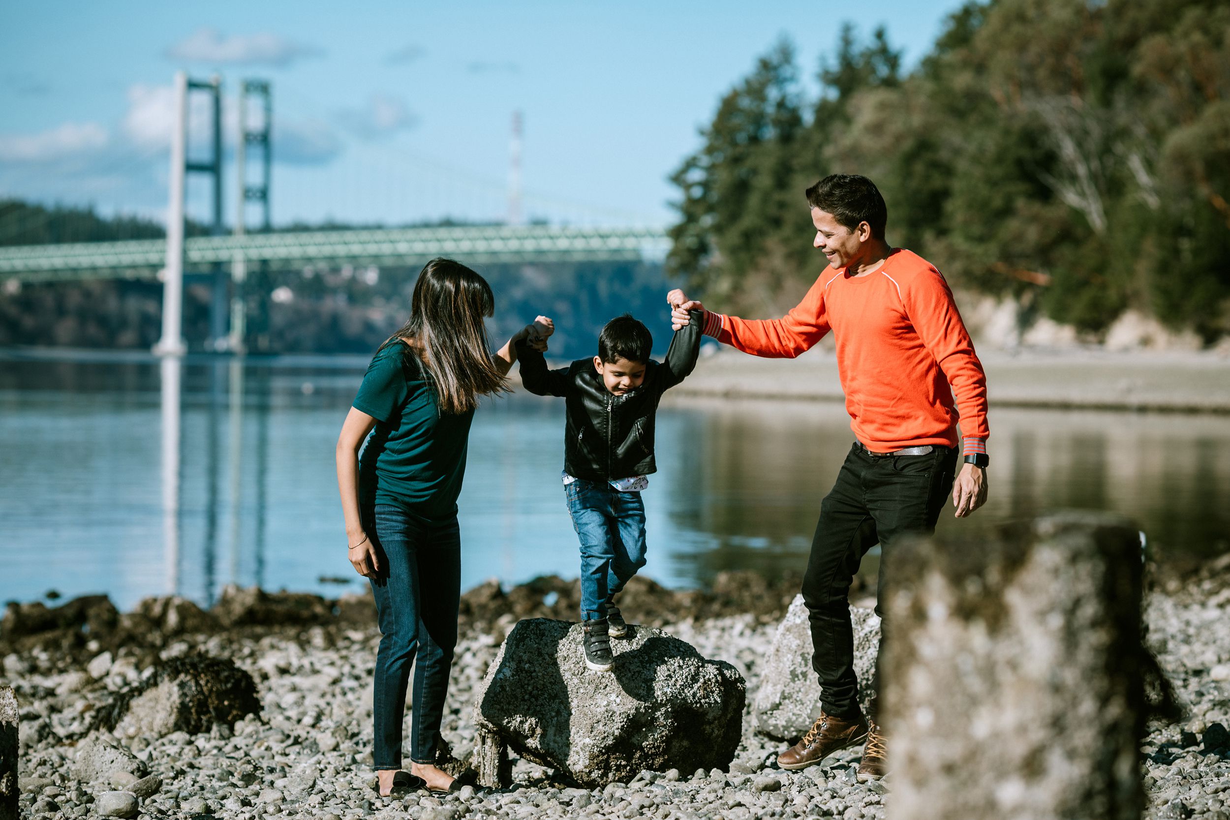 young family spends time together at a Puget Sound beach in Washington state