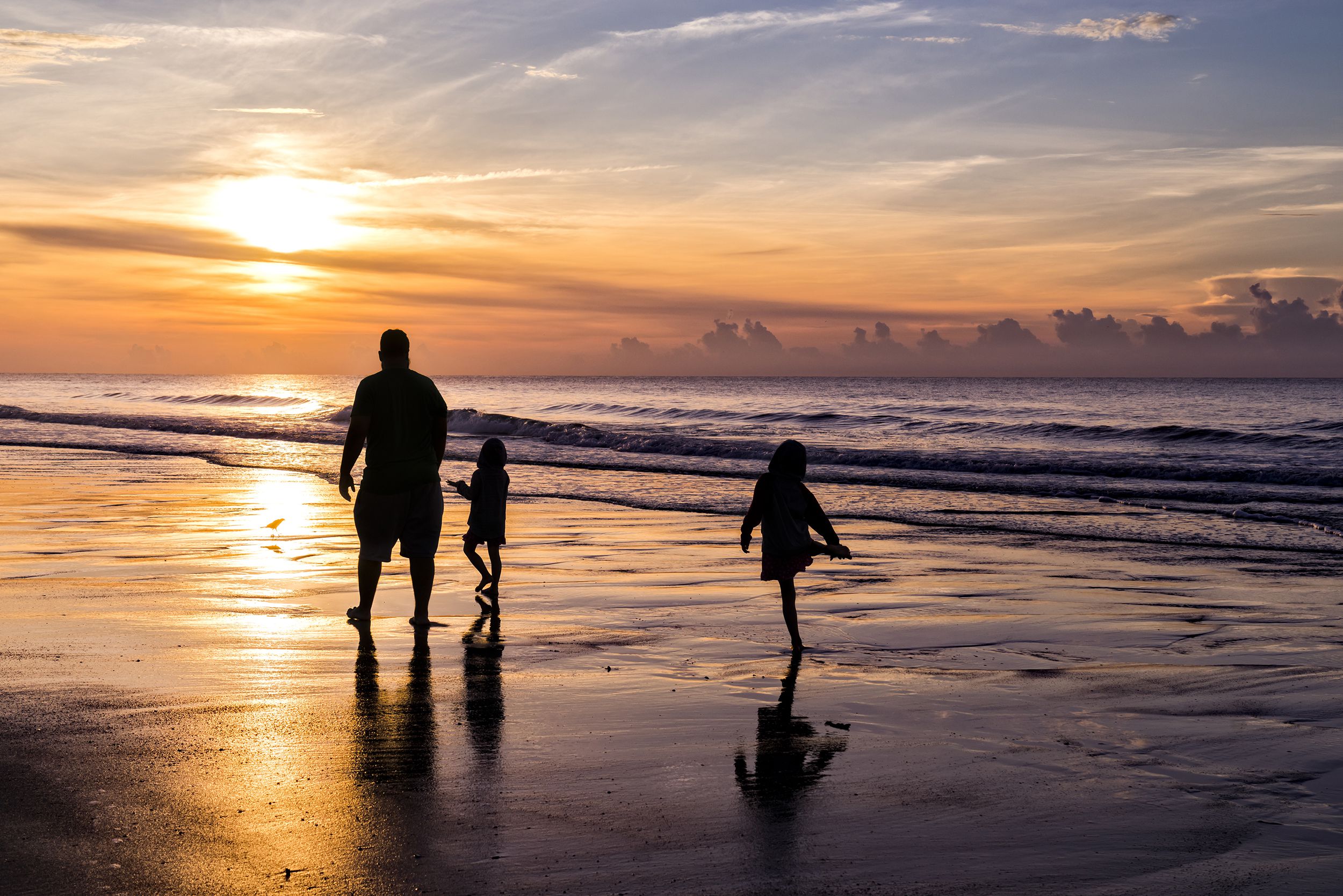 family walking on beach early morning, Garden City Beach, South Carolina