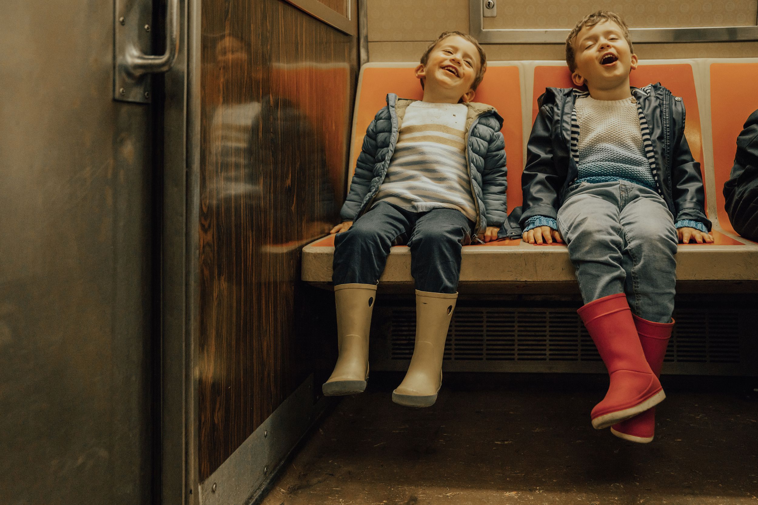 two boys sitting in the subway, NYC