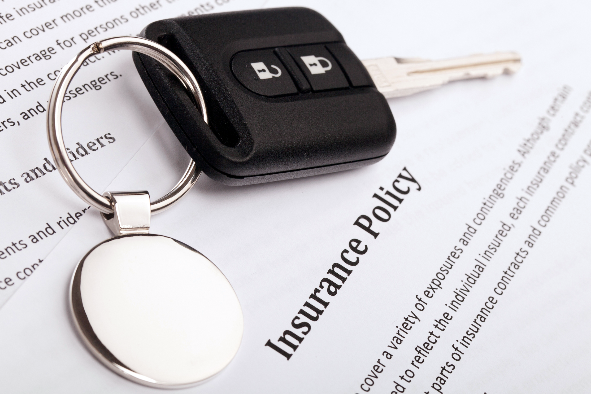 Insurance policy papers with car keys