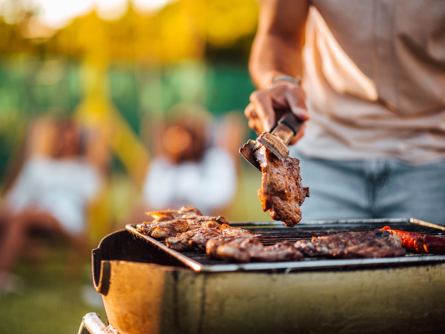 Making barbecue outdoors, close-up, copy space.