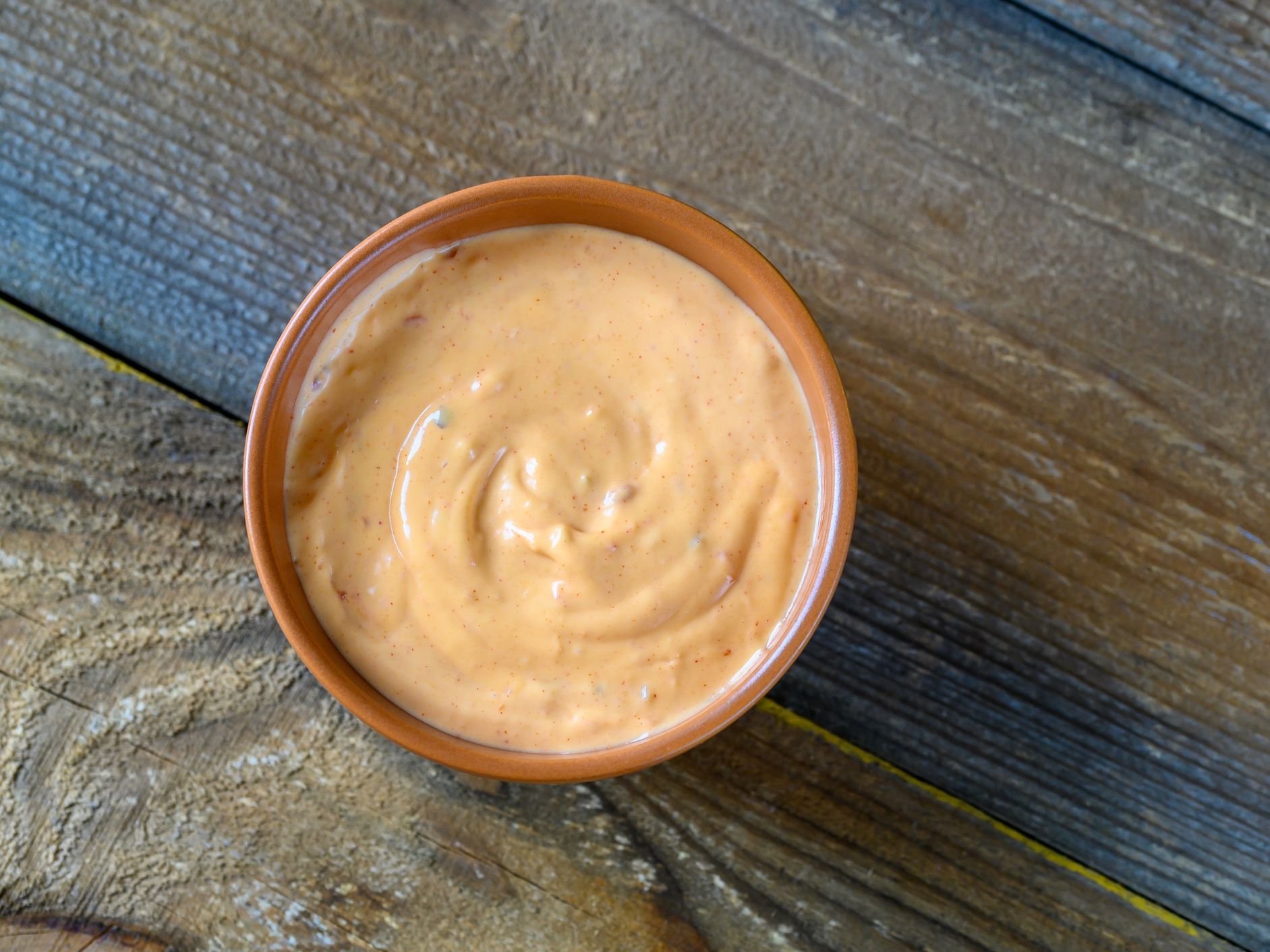 Bowl of Thousand Island dressing on wooden table