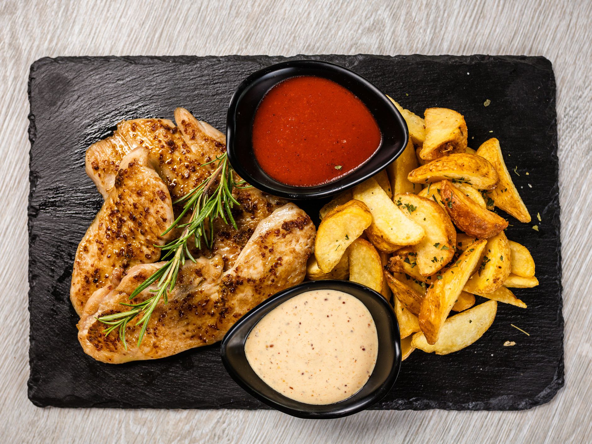 Grilled spicy chicken breast with rosemary and roasted potato