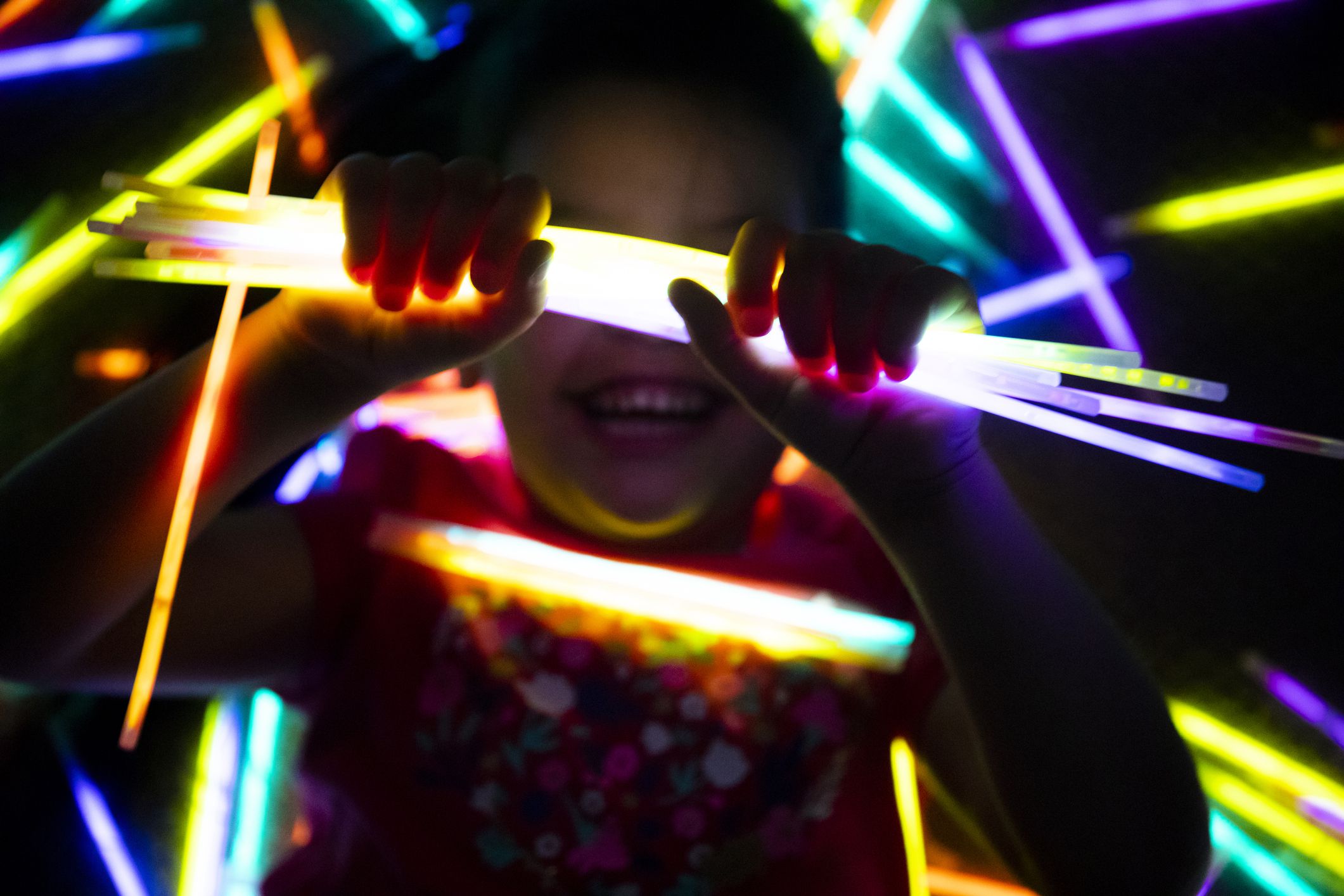 child playing with glow sticks